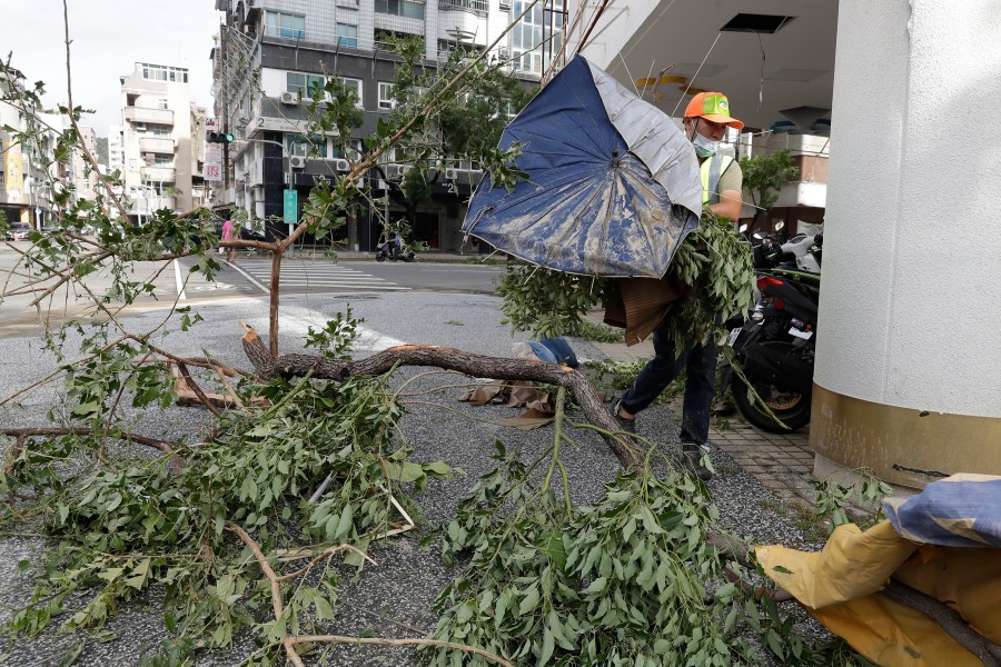 A sanitation worker of Kaohsiung city government clears debris in the aftermath of Typhoon Krathon in Kaohsiung, southern Taiwan, Friday, Oct. 4, 2024. (AP Photo/Chiang Ying-ying)