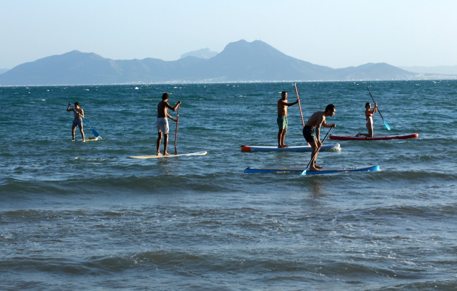 People paddle board in the Mediterranean Sea at Sidi Bousaid beach, in Tunis, Tunisia, Tuesday, Oct. 1, 2024 (AP Photo/Anis Mili)