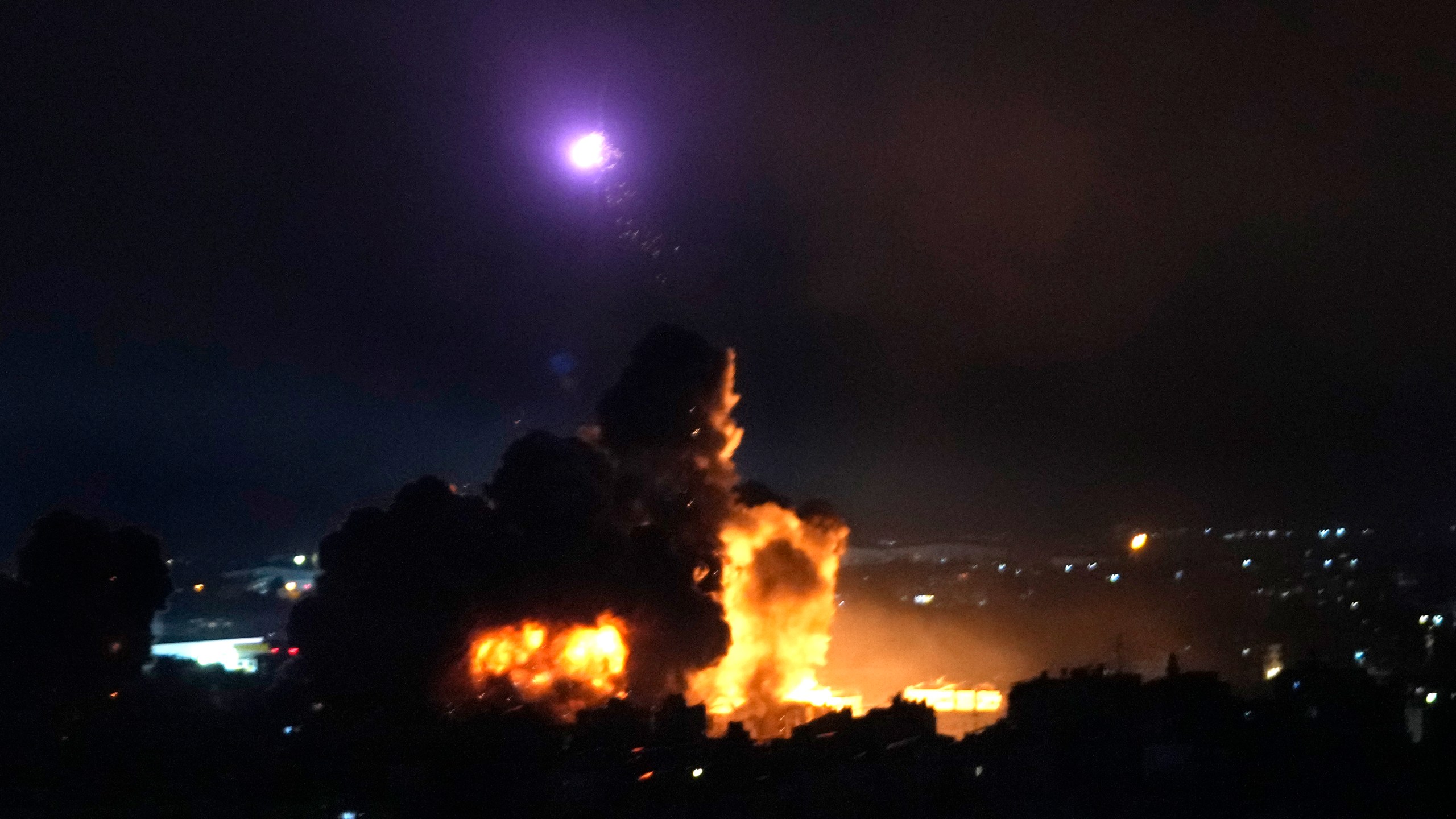 Flames rise from Israeli airstrikes in Dahiyeh, Beirut, Lebanon, Friday, Oct. 4, 2024. (AP Photo/Hussein Malla)