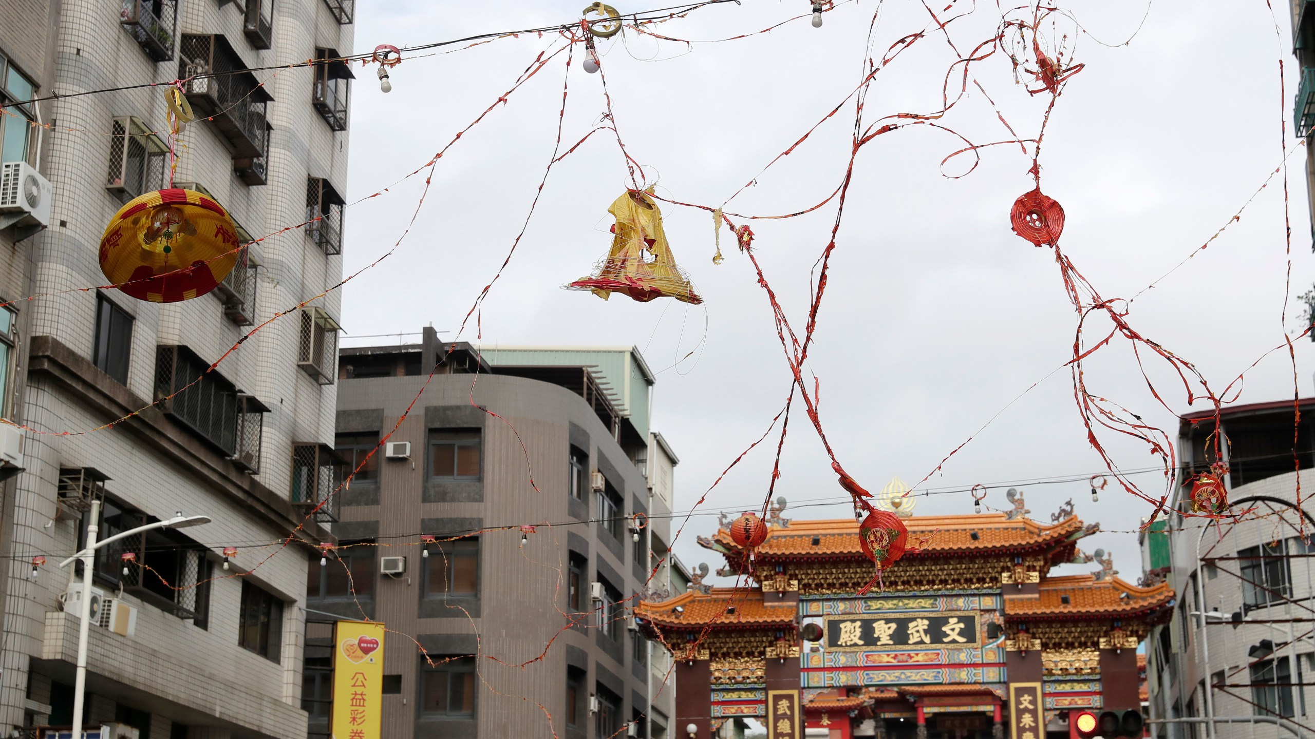 Lanterns destroyed by the wind of Typhoon Krathon, hang outside a temple in Kaohsiung, southern Taiwan, Friday, Oct. 4, 2024. (AP Photo/Chiang Ying-ying)