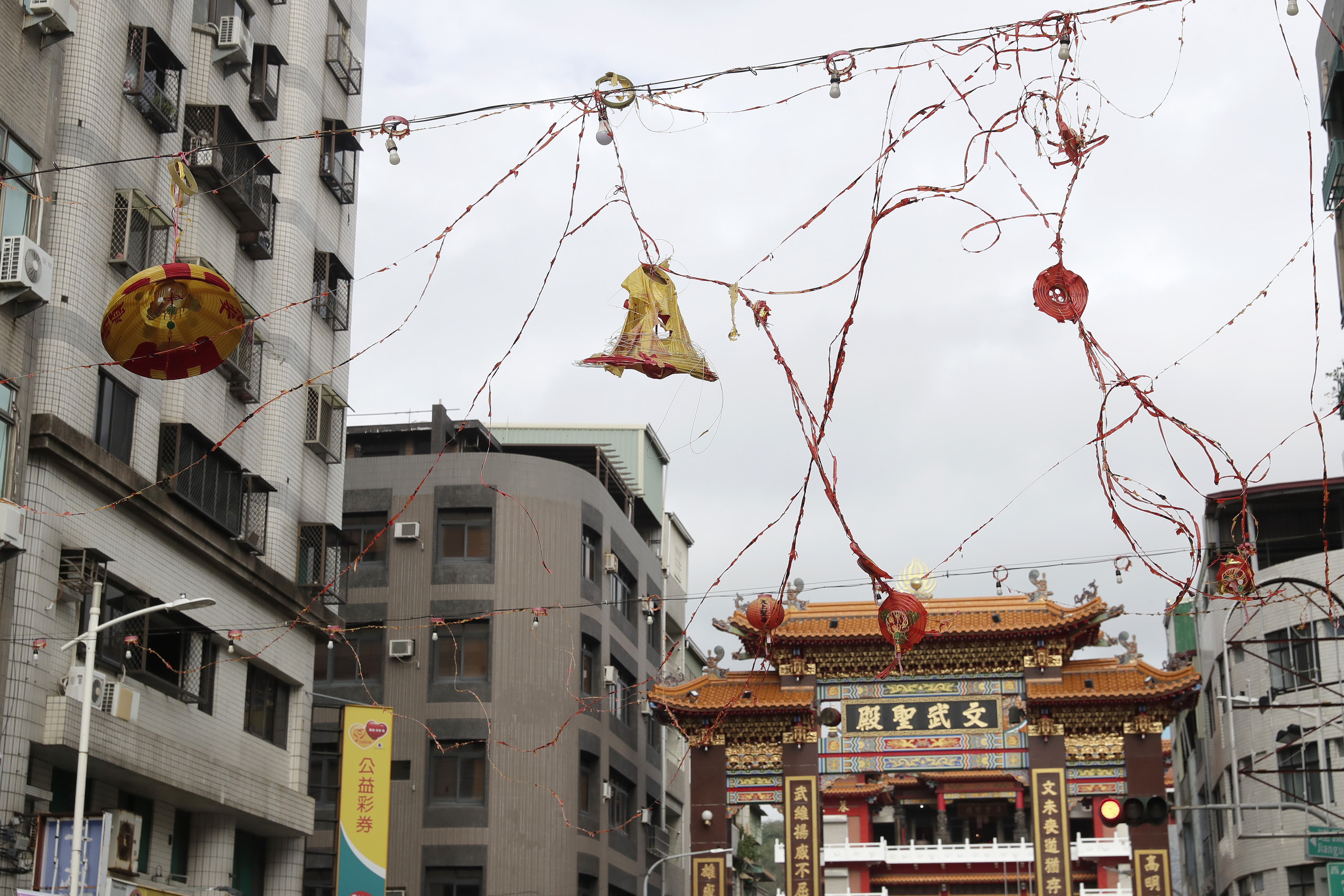 Lanterns destroyed by the wind of Typhoon Krathon, hang outside a temple in Kaohsiung, southern Taiwan, Friday, Oct. 4, 2024. (AP Photo/Chiang Ying-ying)