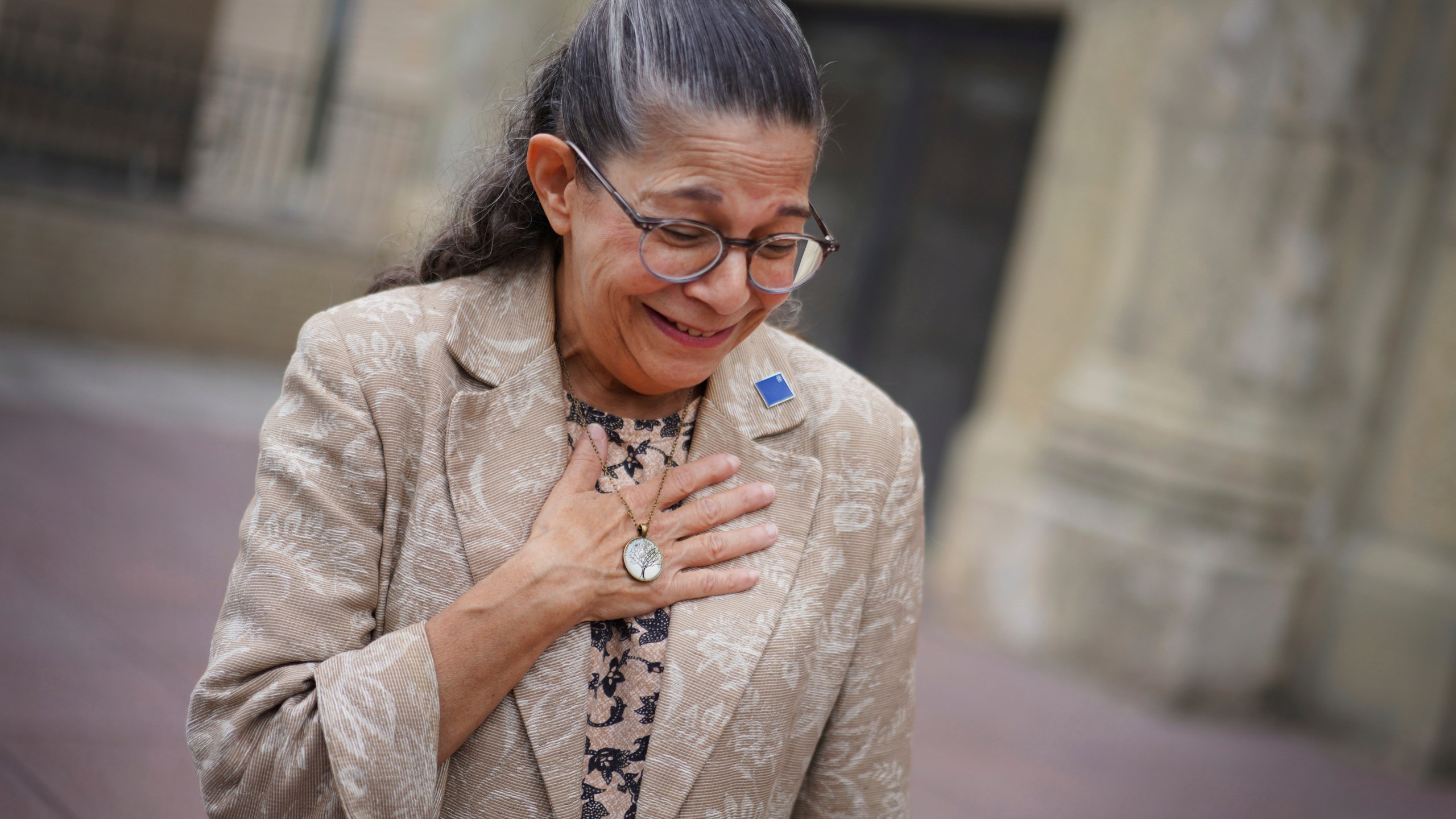 Audrey Glickman, a Tree of Life member who survived the 2018 attack, holds a necklace representing the synagogue, Friday, Sept. 27, 2024, in Pittsburgh. (AP Photo/Jessie Wardarski)