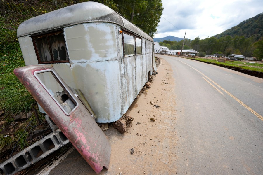 A trailer moved by floodwater sits on the side of a road in the aftermath of Hurricane Helene, Thursday, Oct. 3, 2024, in Pensacola, N.C. (AP Photo/Mike Stewart)