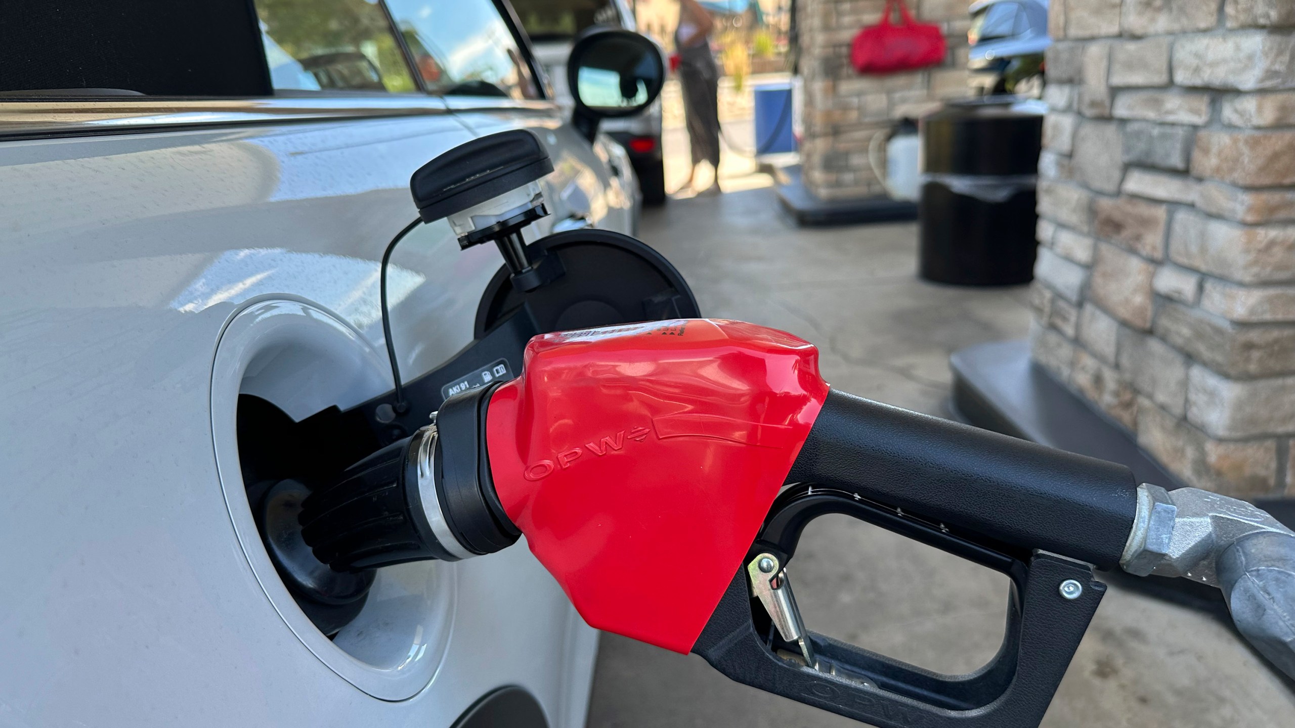 FILE - A motorist fills up the gasoline tank of a vehicle at a Costco warehouse Aug. 22, 2024, in Parker, Colo. (AP Photo/David Zalubowski, File)