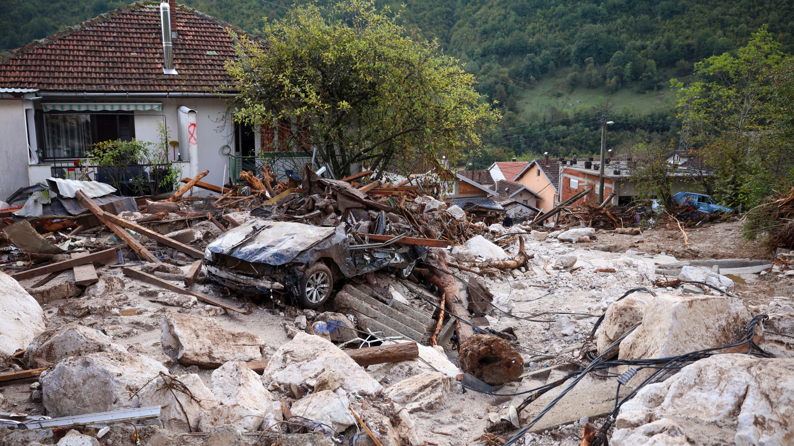 A damaged car is seen after flood hit the village of Donja Jablanica, Bosnia, Saturday, Oct. 5, 2024. (AP Photo/Armin Durgut)