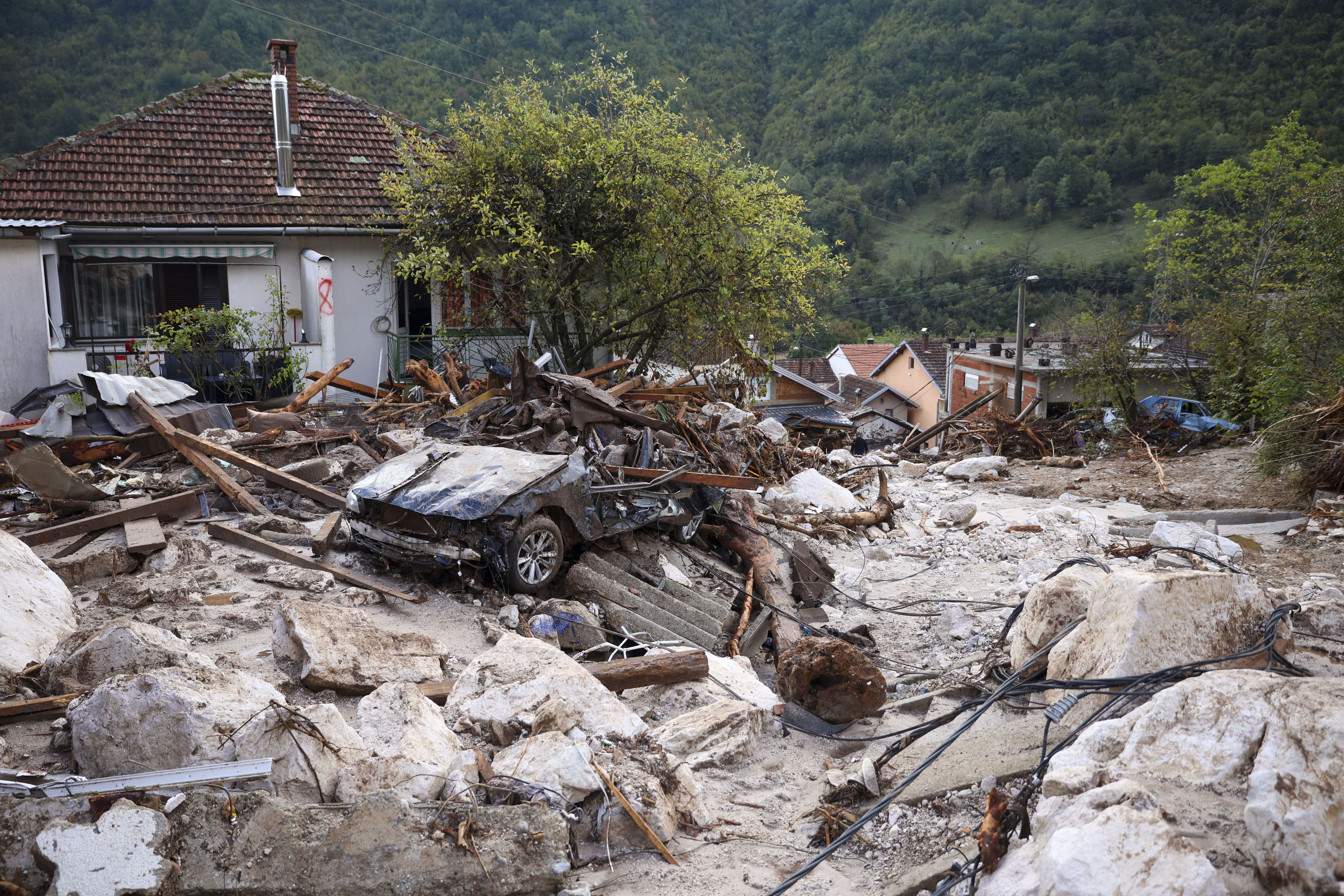 A damaged car is seen after flood hit the village of Donja Jablanica, Bosnia, Saturday, Oct. 5, 2024. (AP Photo/Armin Durgut)