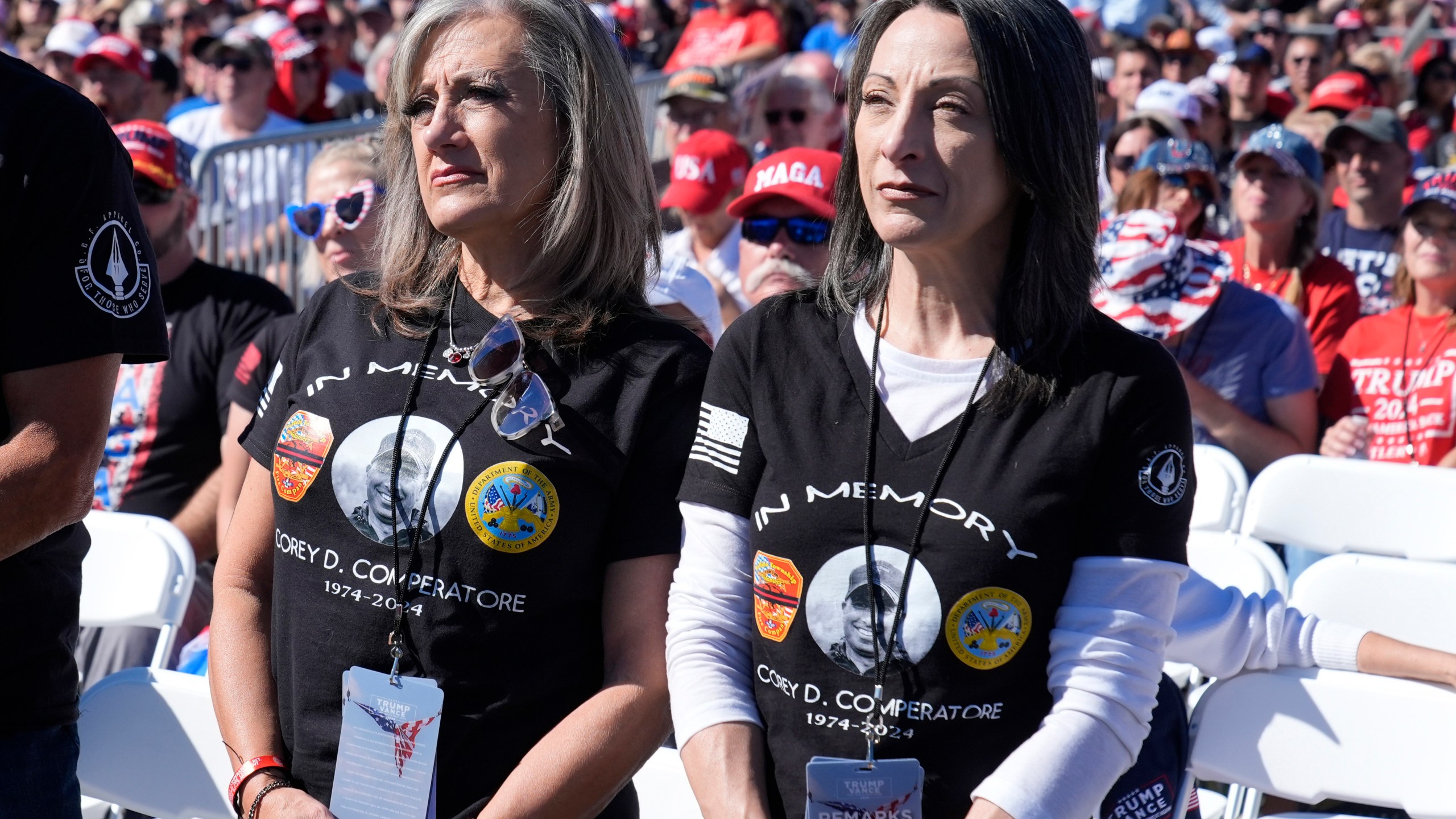 Kelly Comperatore-Meeder, left, and Dawn Comperatore-Schafer, sisters of firefighter Corey Comperatore, who died as he shielded family members from gunfire, attend a campaign event for Republican presidential nominee former President Donald Trump, at the Butler Farm Show, the site where a gunman tried to assassinate Trump in July, Saturday, Oct. 5, 2024, in Butler, Pa. (AP Photo/Alex Brandon)