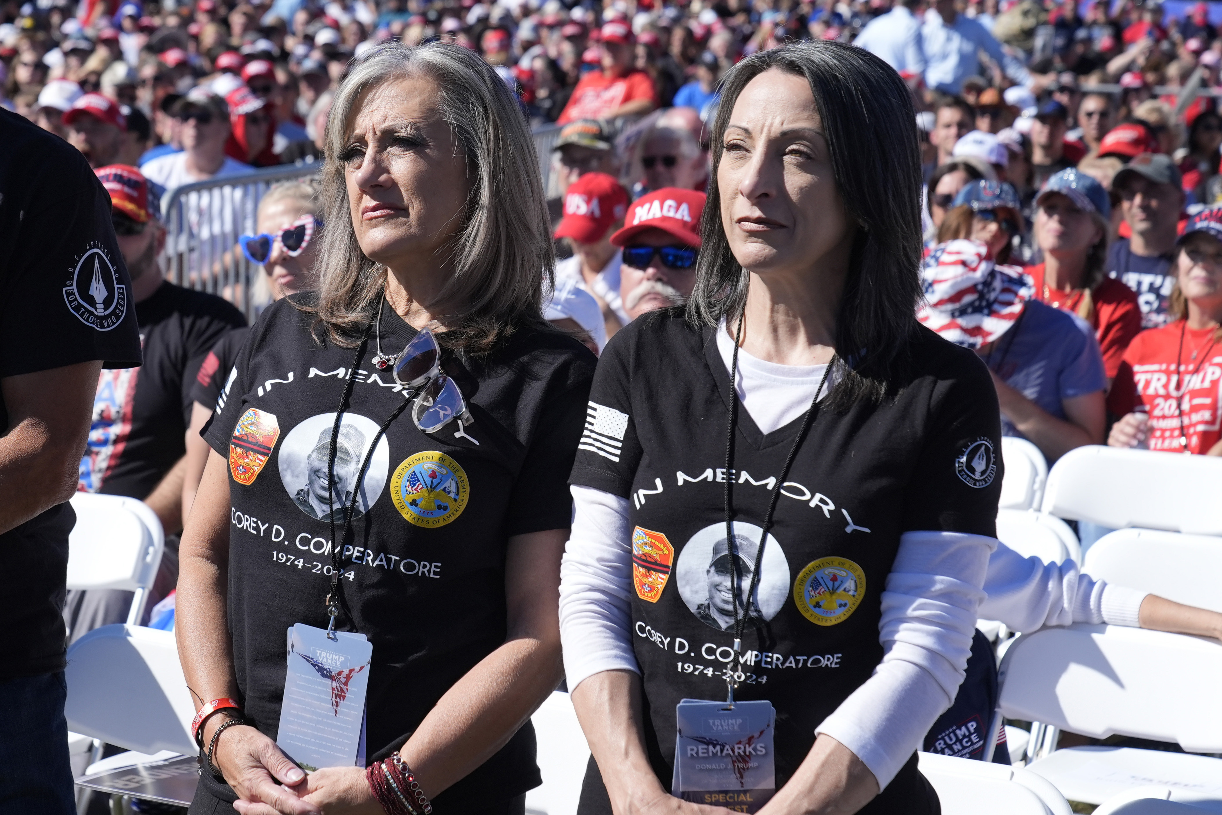 Kelly Comperatore-Meeder, left, and Dawn Comperatore-Schafer, sisters of firefighter Corey Comperatore, who died as he shielded family members from gunfire, attend a campaign event for Republican presidential nominee former President Donald Trump, at the Butler Farm Show, the site where a gunman tried to assassinate Trump in July, Saturday, Oct. 5, 2024, in Butler, Pa. (AP Photo/Alex Brandon)