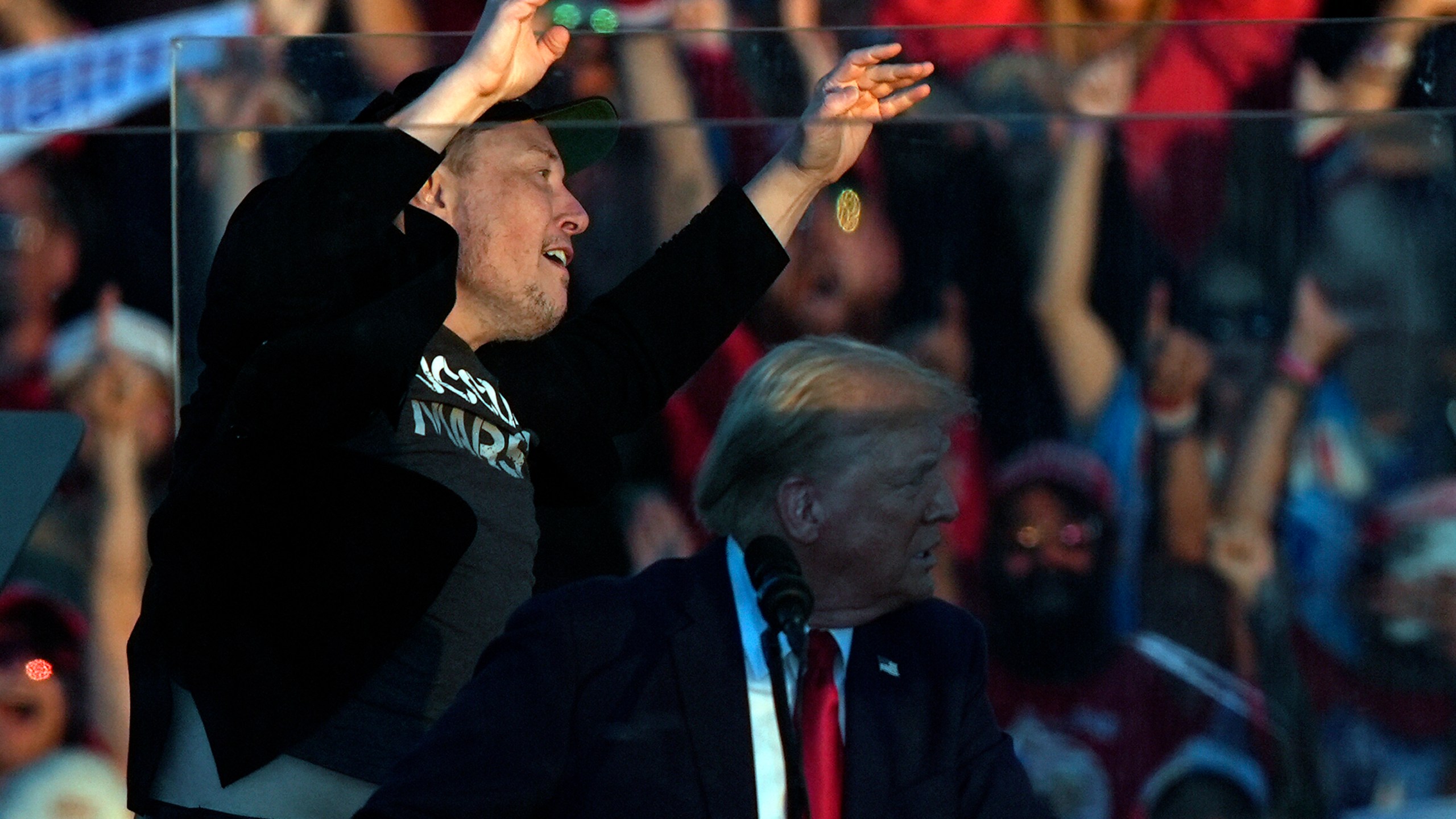 Elon Musk jumps on the stage behind Republican presidential nominee former President Donald Trump during a campaign rally at the Butler Farm Show, Saturday, Oct. 5, 2024, in Butler, Pa. (AP Photo/Julia Demaree Nikhinson)