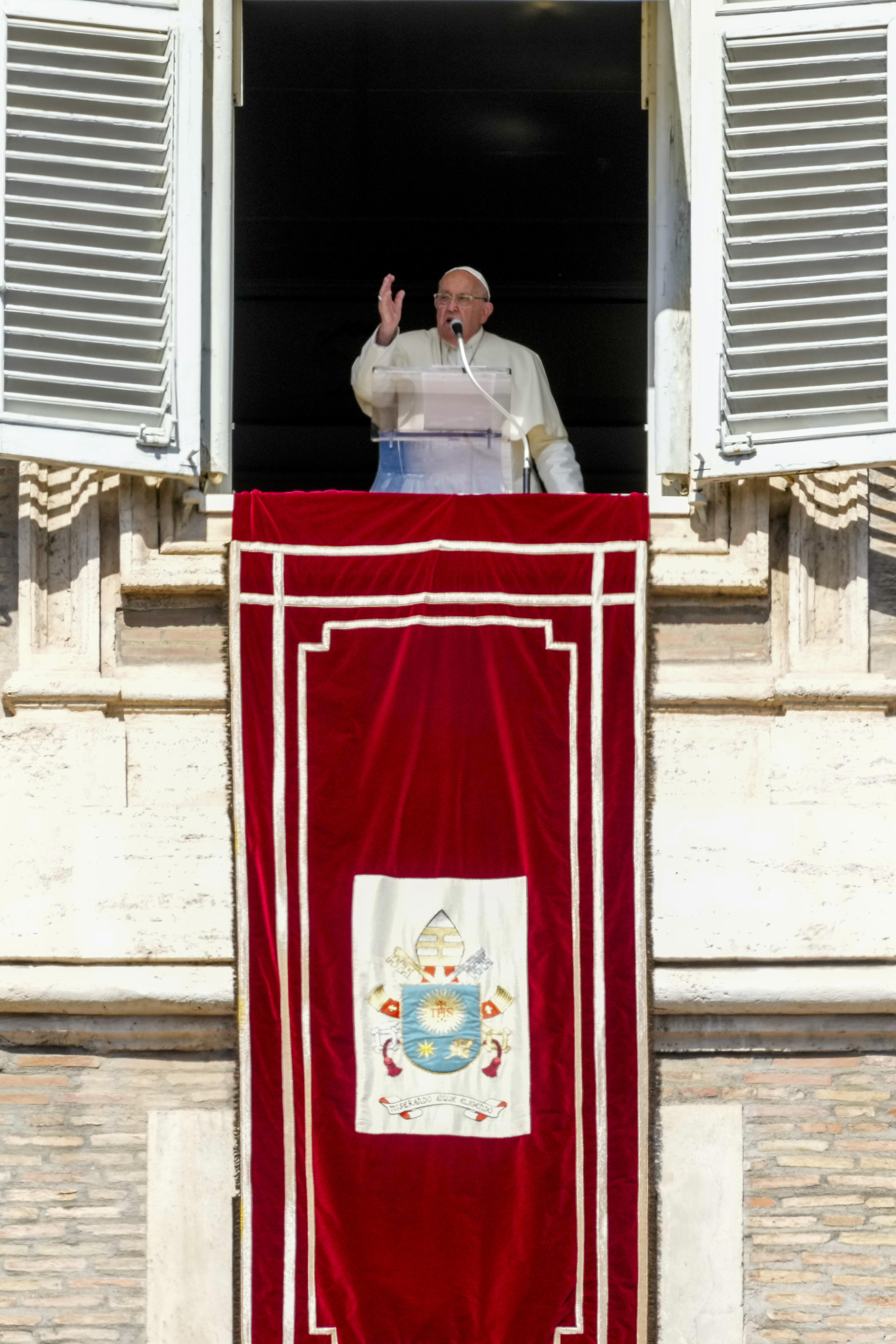 Pope Francis appears at his studio window for the traditional noon blessing of faithful and pilgrims gathered in St. Peter's Square at The Vatican, Sunday, Oct. 6, 2024. (AP Photo/Andrew Medichini)