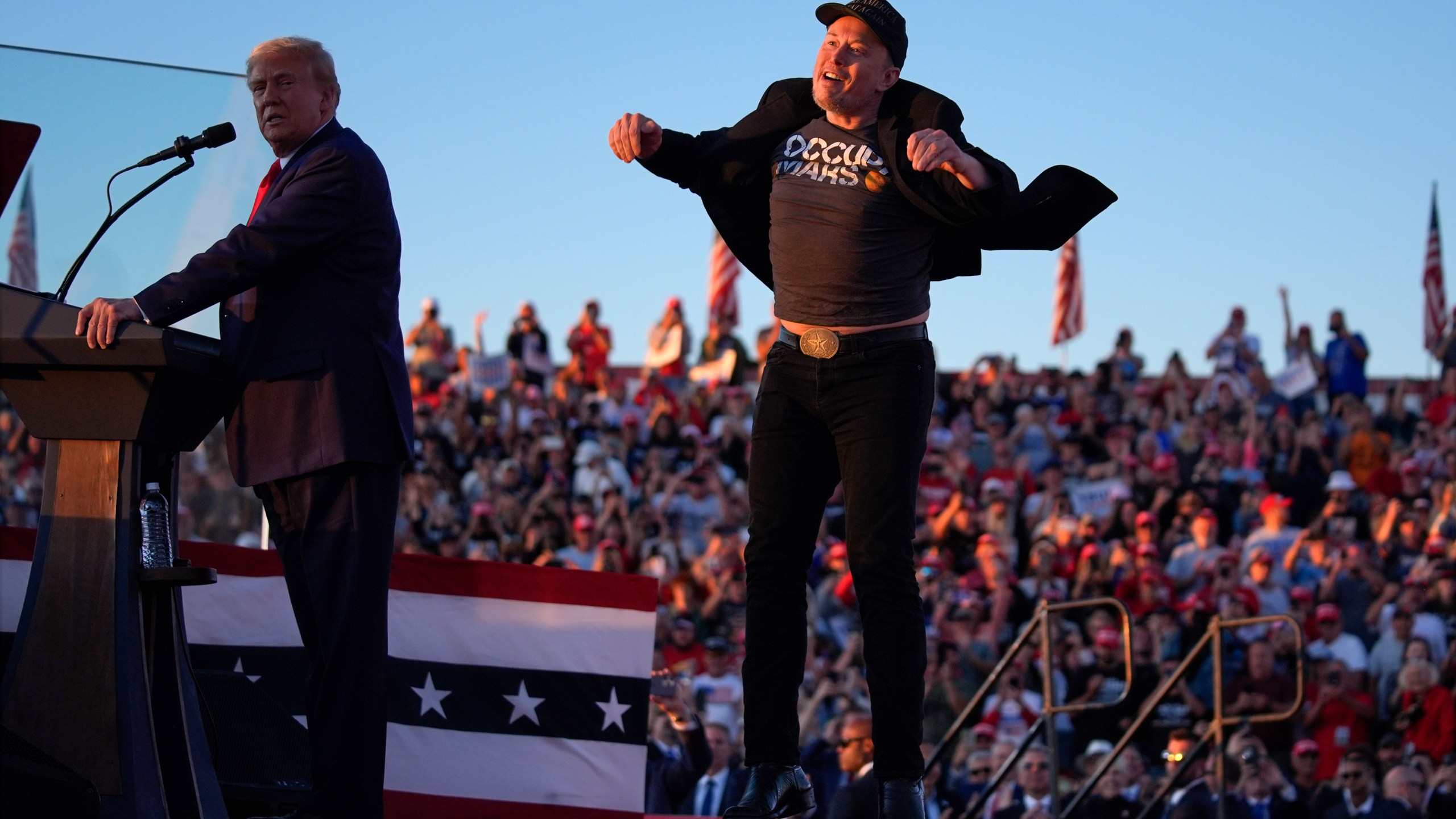 Elon Musk jumps on the stage as Republican presidential nominee former President Donald Trump speaks at a campaign rally at the Butler Farm Show, Saturday, Oct. 5, 2024, in Butler, Pa. (AP Photo/Evan Vucci)