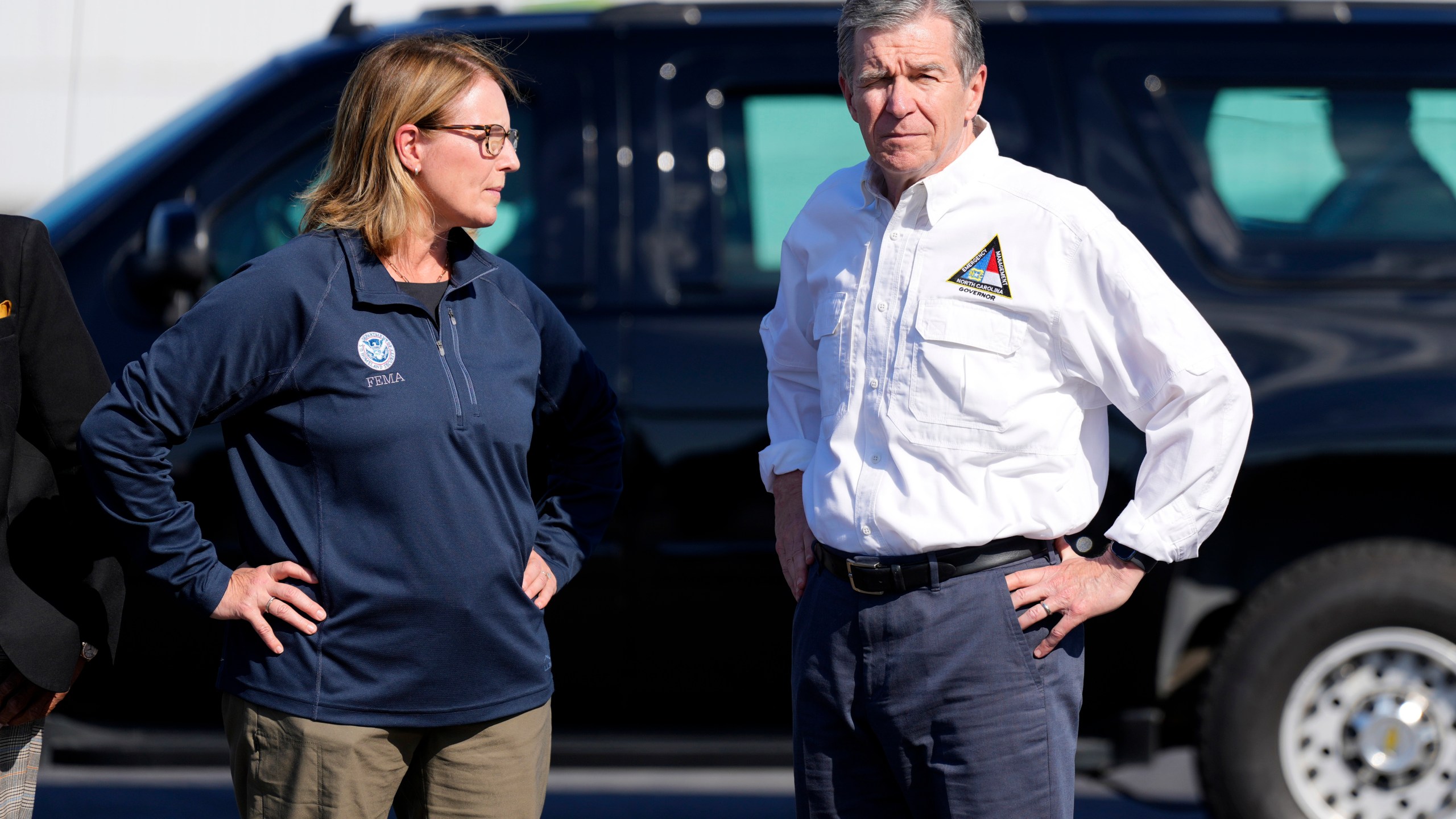 North Carolina Gov. Roy Cooper, right, and Deanne Criswell, Administrator of the U.S. Federal Emergency Management Agency, await the arrival of Democratic presidential nominee Vice President Kamala Harris for a briefing on the damage from Hurricane Helene, at Charlotte Douglas International Airport, Saturday, October 5, 2024, in Charlotte, N.C. (AP Photo/Chris Carlson)