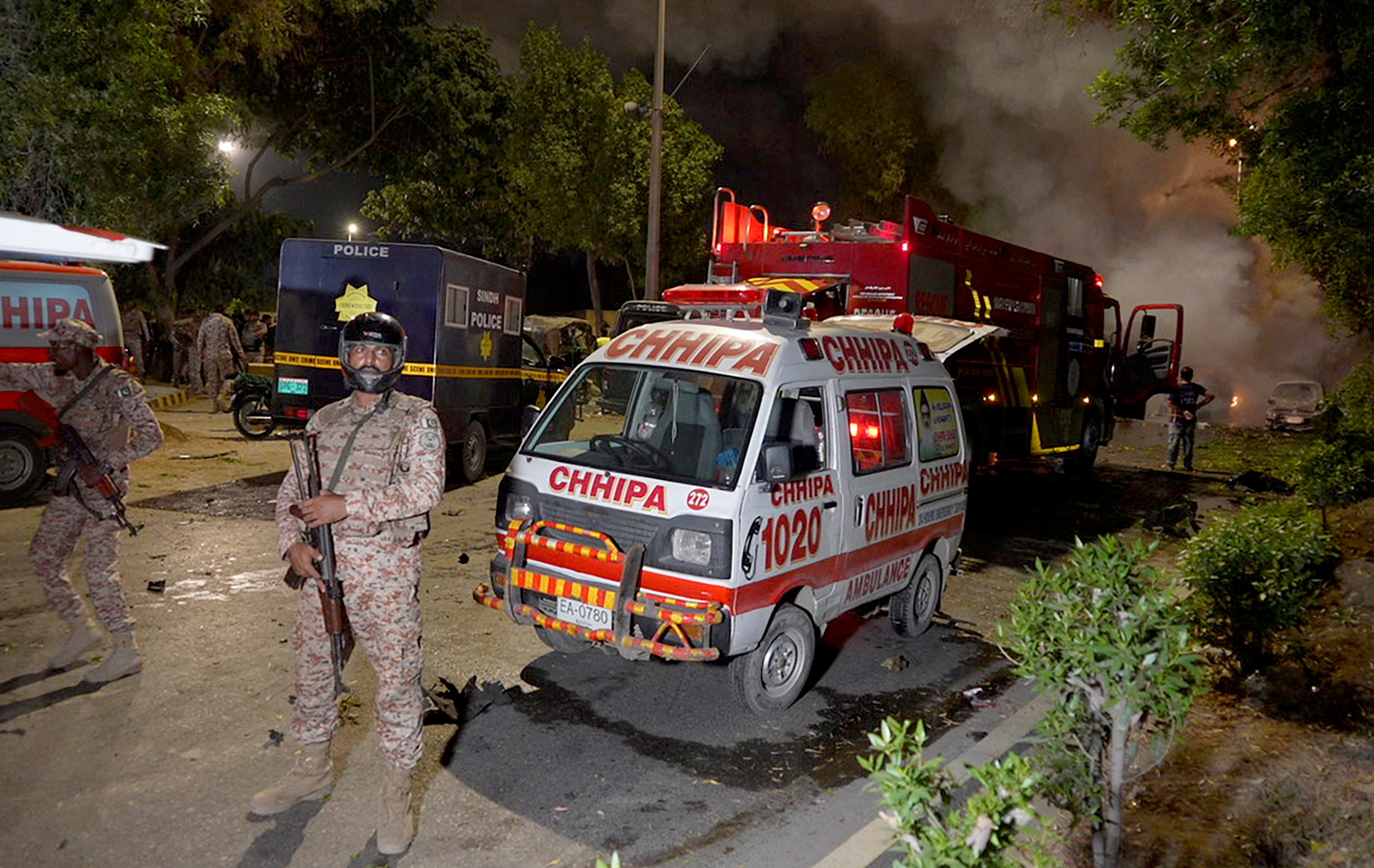 Paramilitary soldiers stand guard close to the site of an explosion that caused injuries and destroyed vehicles at outside the Karachi airport, Pakistan, Sunday, Oct. 6, 2024. (AP Photo/Mohammad Farooq)