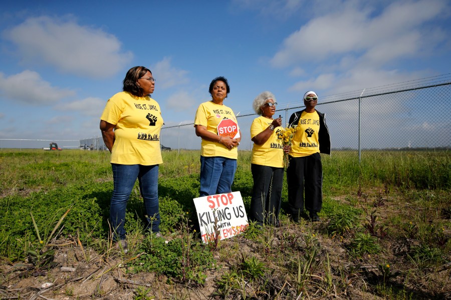 FILE - From left, Myrtle Felton, Sharon Lavigne, Gail LeBoeuf and Rita Cooper, members of RISE St. James, conduct a live stream video on property owned by Formosa in St. James Parish, La., Wednesday, March 11, 2020. (AP Photo/Gerald Herbert, File)