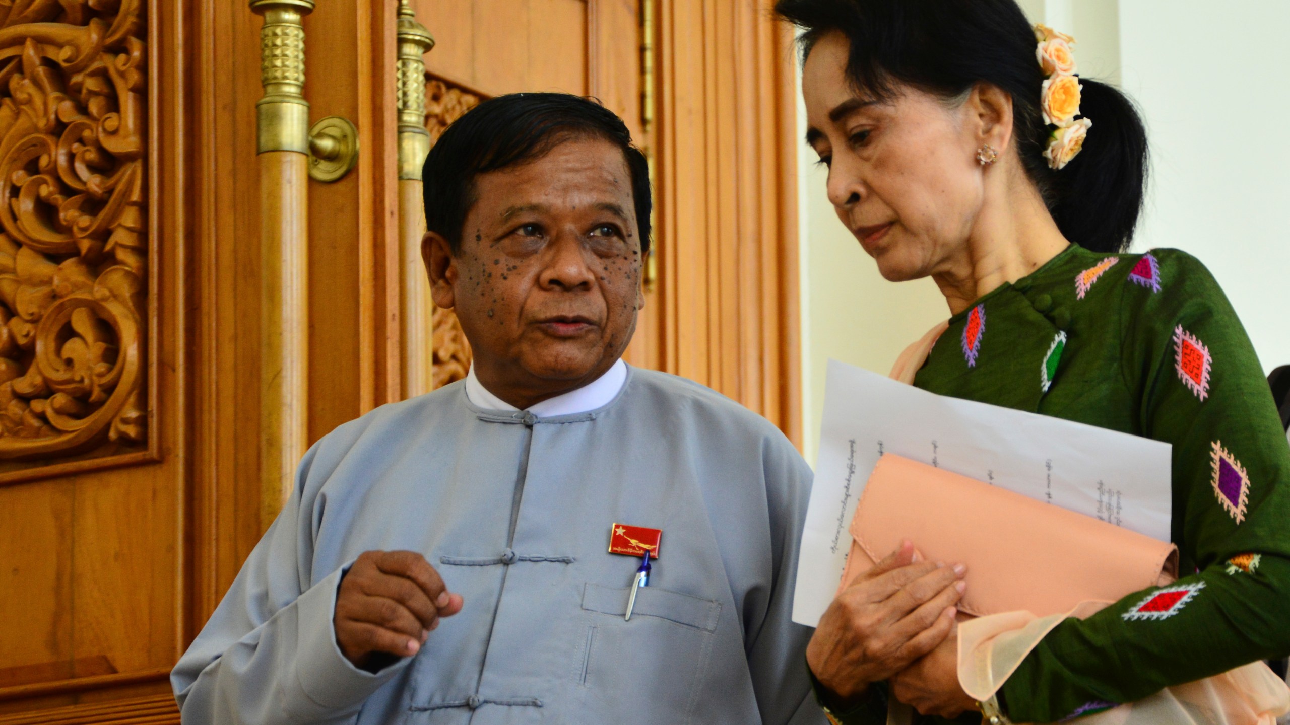 FILE - Zaw Myint Maung, left, an imprisoned politician and a close colleague of Myanmar’s ousted leader Aung San Suu Kyi, right, talks with Suu Kyi at Parliament in Naypyitaw, Myanmar, on July 23, 2015. (AP Photo/Aung Shine Oo, File)