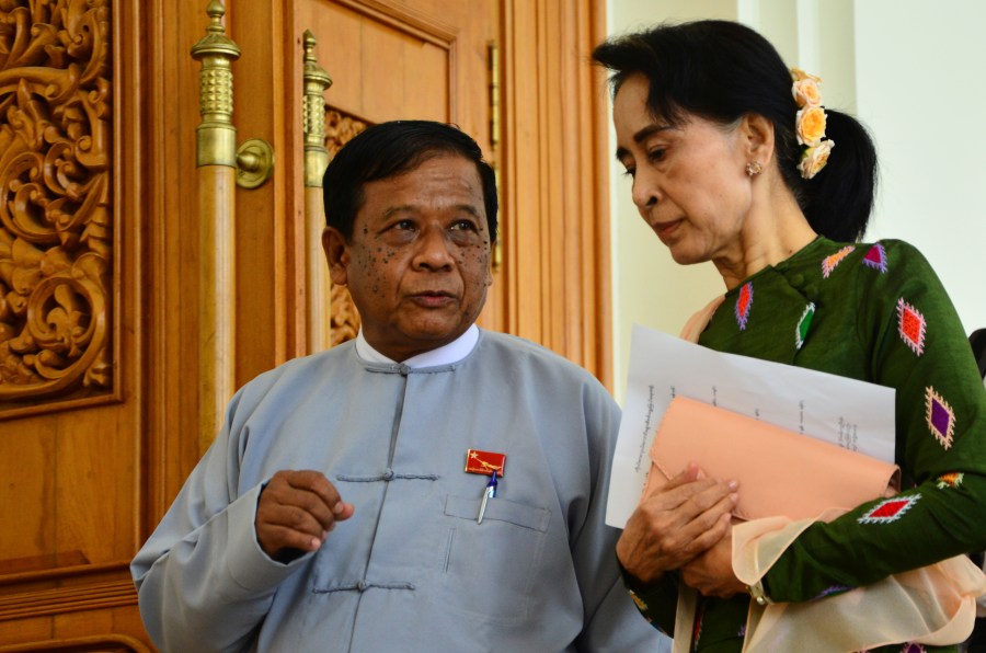 FILE - Zaw Myint Maung, left, an imprisoned politician and a close colleague of Myanmar’s ousted leader Aung San Suu Kyi, right, talks with Suu Kyi at Parliament in Naypyitaw, Myanmar, on July 23, 2015. (AP Photo/Aung Shine Oo, File)