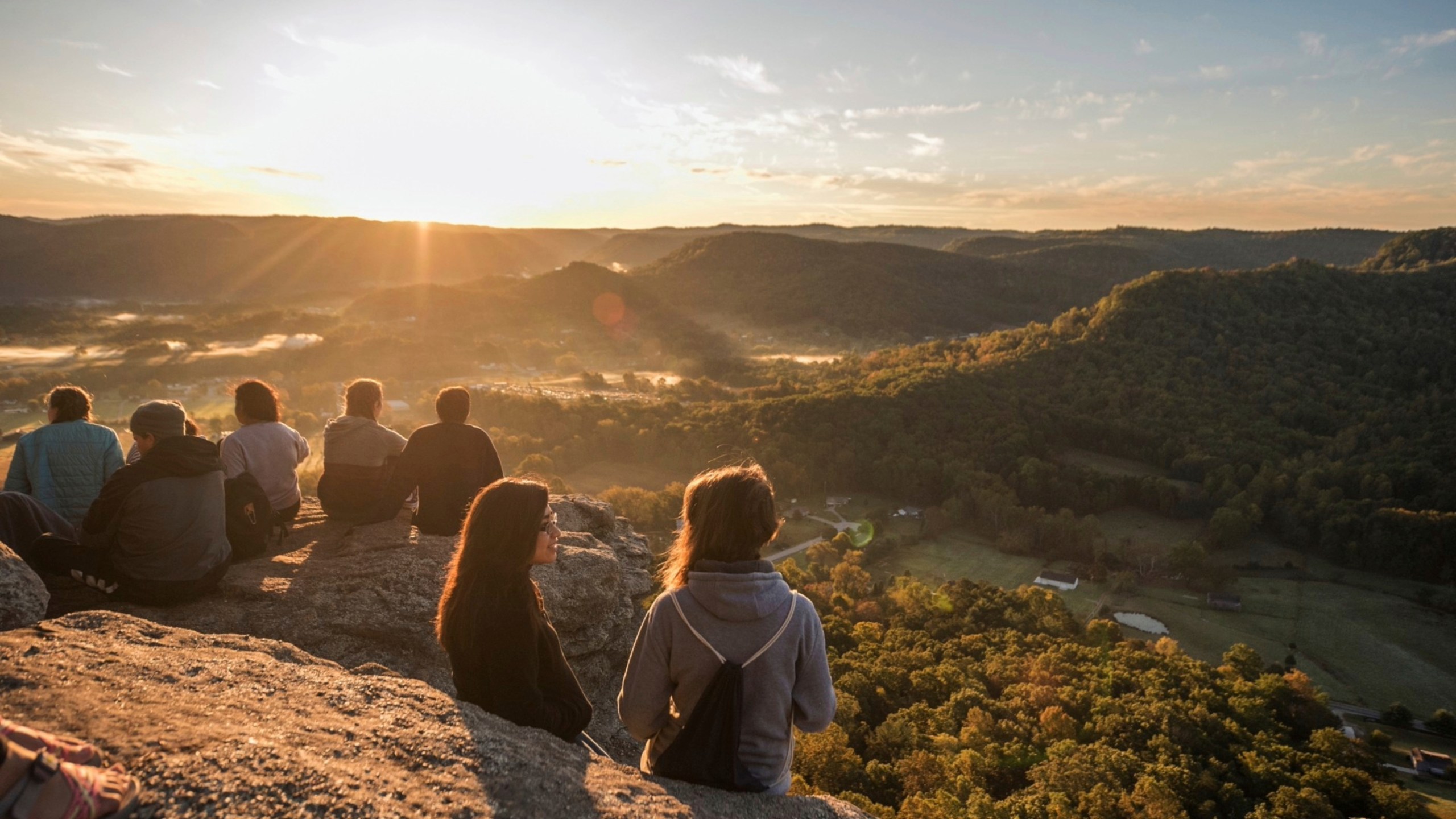 Students sit atop Indian Fort Mountain in Berea, Kentucky, during Berea College Mountain Day in Oct. 2023, an annual event held to celebrate the surrounding Appalachian region. The Partners for Rural Impact are taking a philanthropic model from Harlem and adapting it for Appalachian Kentucky. (Partners for Rural Impact via AP)