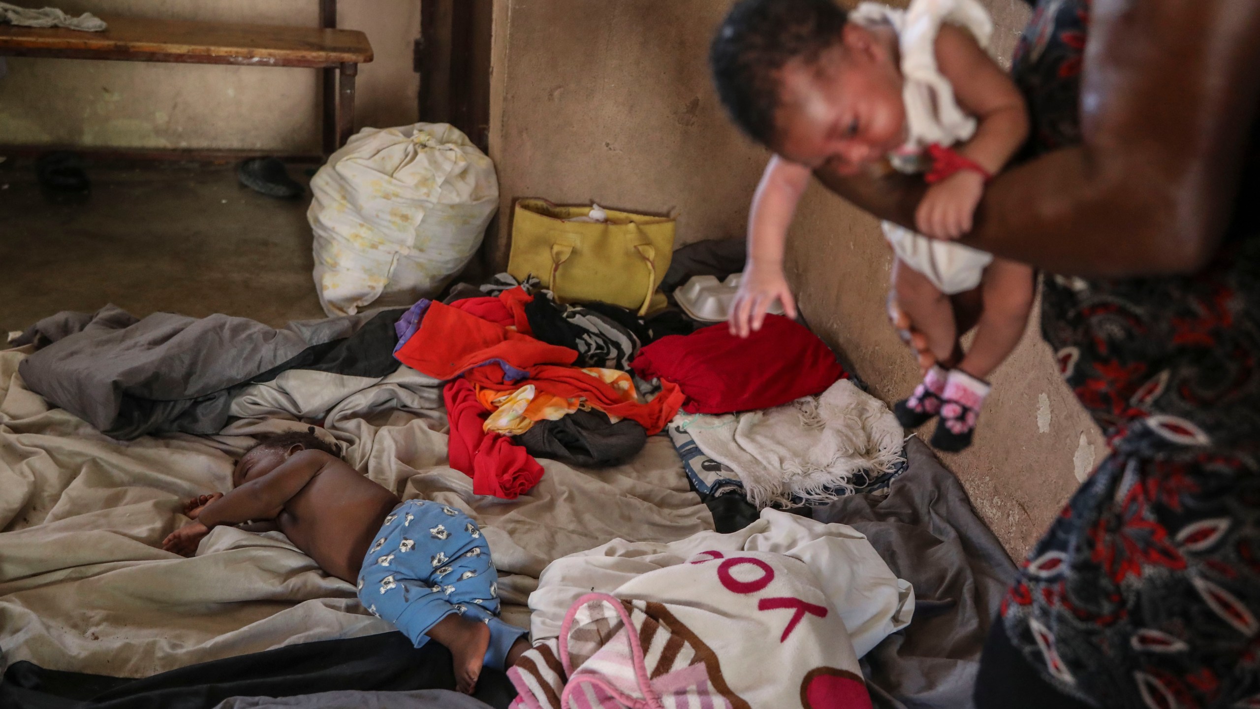 People displaced by armed gang attacks rest at the Antoinette Dessalines National School, a makeshift shelter, in Saint-Marc, Haiti, Sunday, Oct. 6, 2024. (AP Photo/Odelyn Joseph)