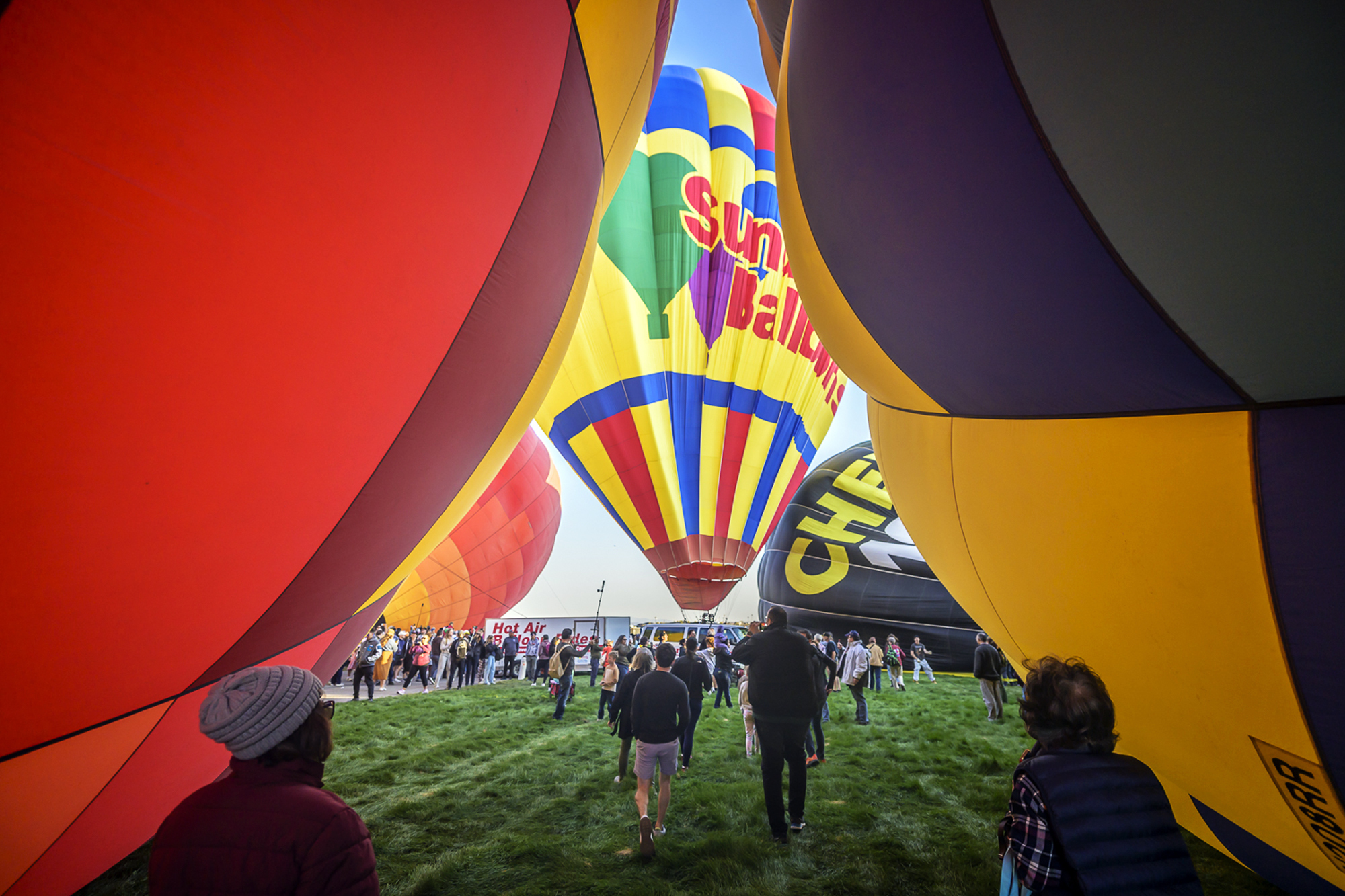 Spectators watch as hot air balloons take off during the mass ascension at the 52nd Albuquerque International Balloon Fiesta in Albuquerque, N.M., on Saturday, Oct. 5, 2024. (AP Photo/Roberto E. Rosales)