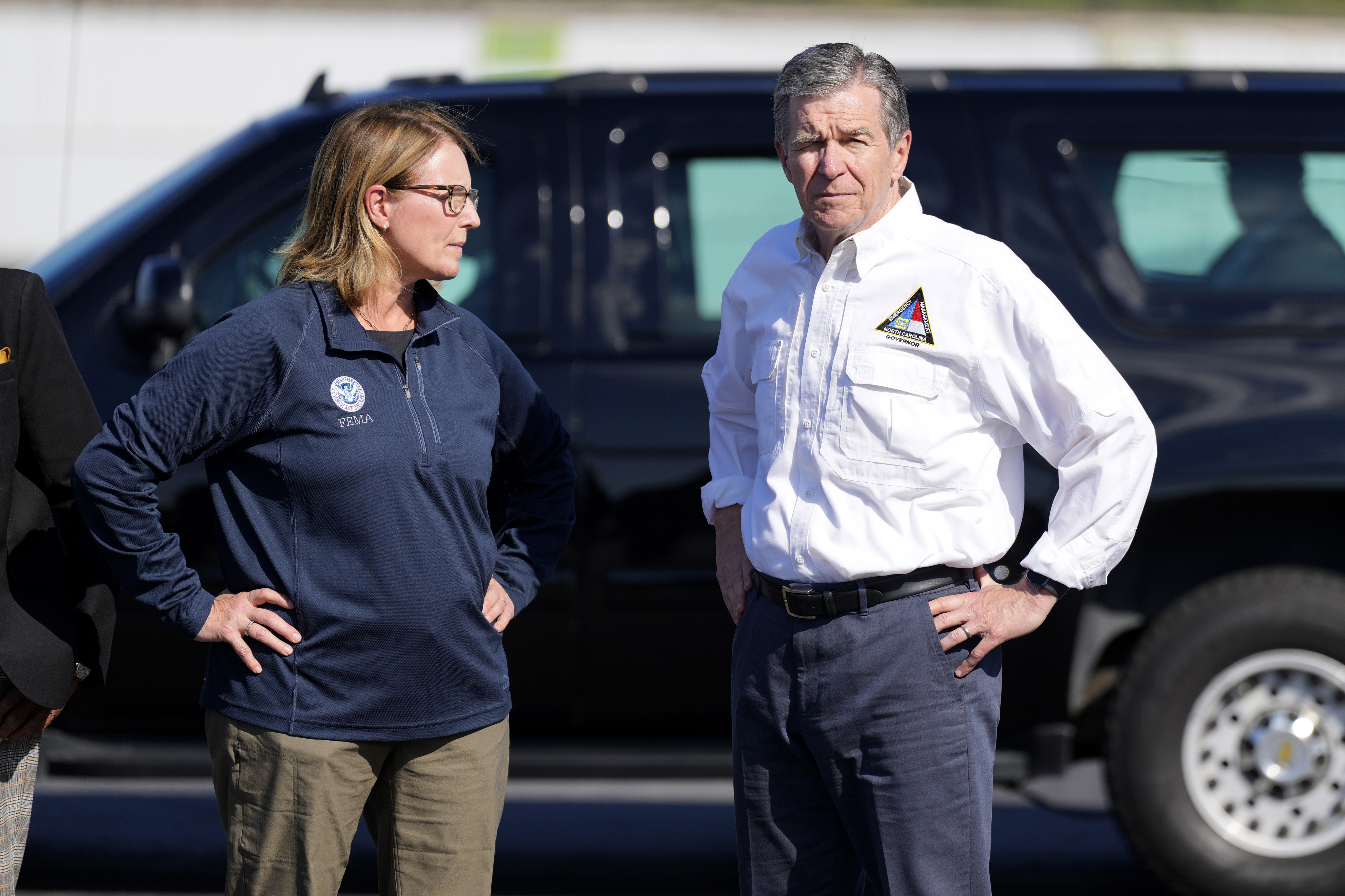 FILE- North Carolina Gov. Roy Cooper, right, and Deanne Criswell, Administrator of the U.S. Federal Emergency Management Agency, await the arrival of Democratic presidential nominee Vice President Kamala Harris for a briefing on the damage from Hurricane Helene, at Charlotte Douglas International Airport, Oct. 5, 2024, in Charlotte, N.C. (AP Photo/Chris Carlson, file)