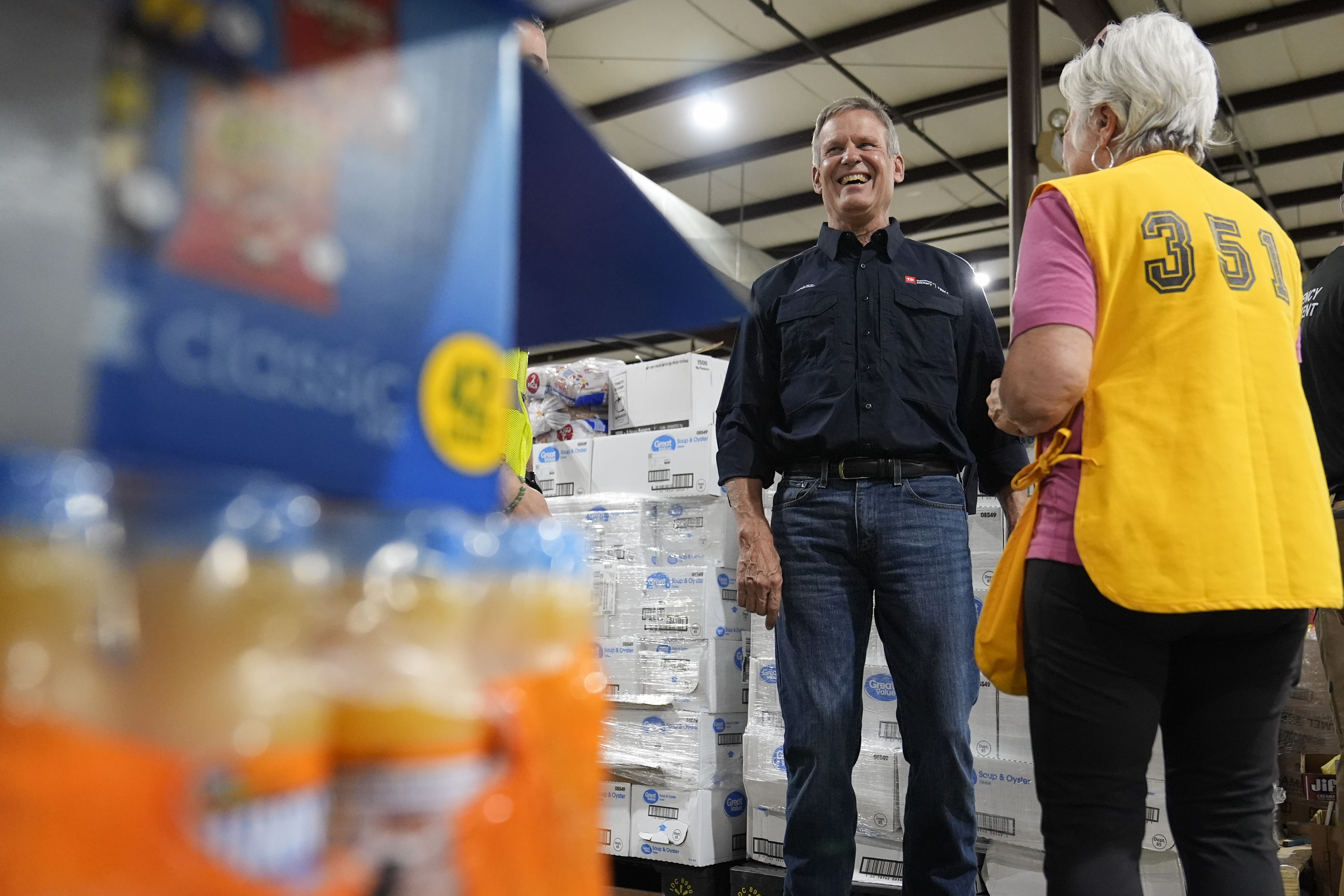 Gov. Bill Lee visits with a volunteer at the East Tennessee Disaster Relief Center, for Hurricane Helene disaster response Monday, Oct. 7, 2024, in Bristol, Tenn. (AP Photo/George Walker IV via Pool)