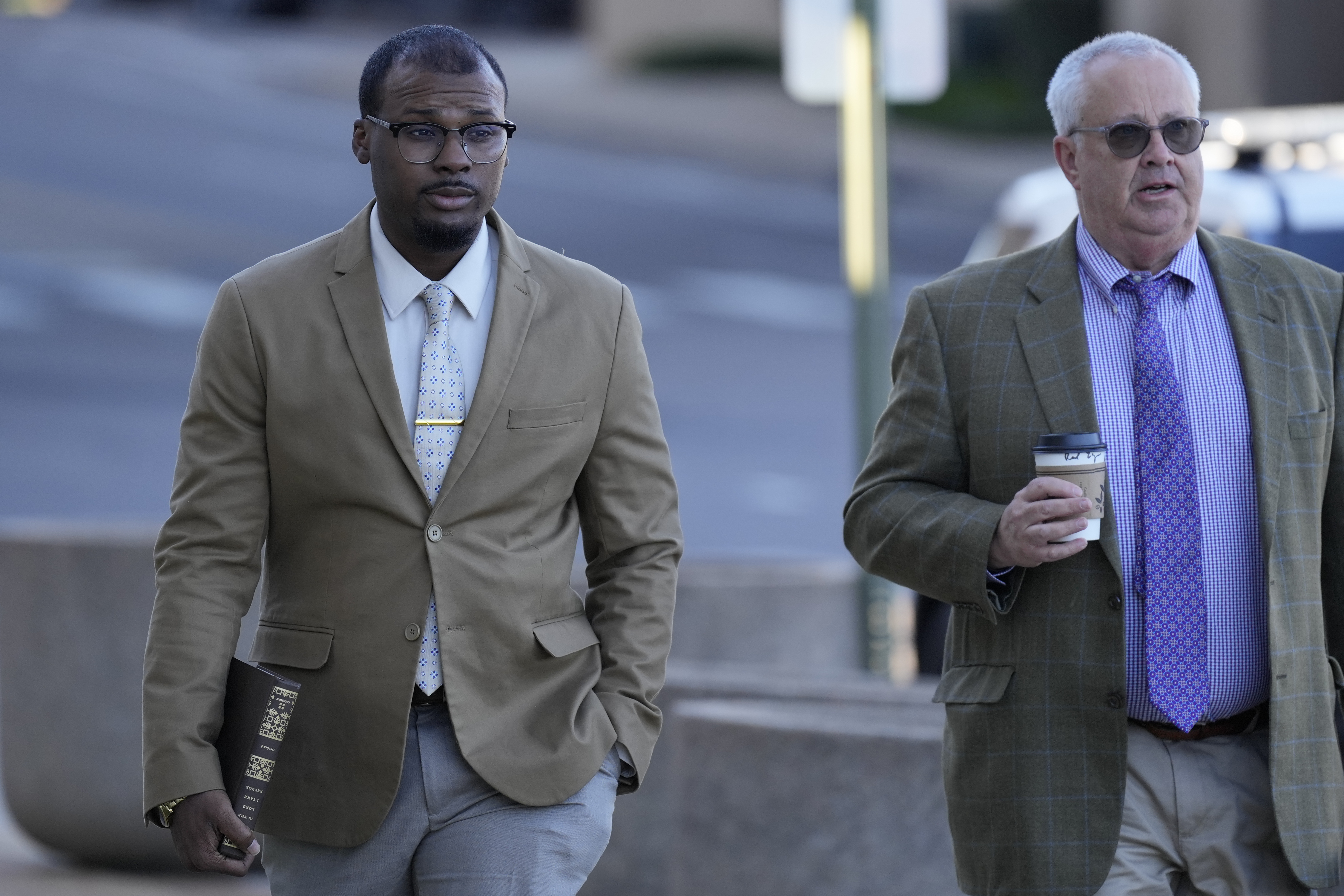 Justin Smith, left, one of three former Memphis police officers charged in the 2023 fatal beating of Tyre Nichols, arrives at the federal courthouse with his attorney Martin Zummach, right, for the day's proceedings Thursday, Oct. 3, 2024, in Memphis, Tenn. (AP Photo/George Walker IV)