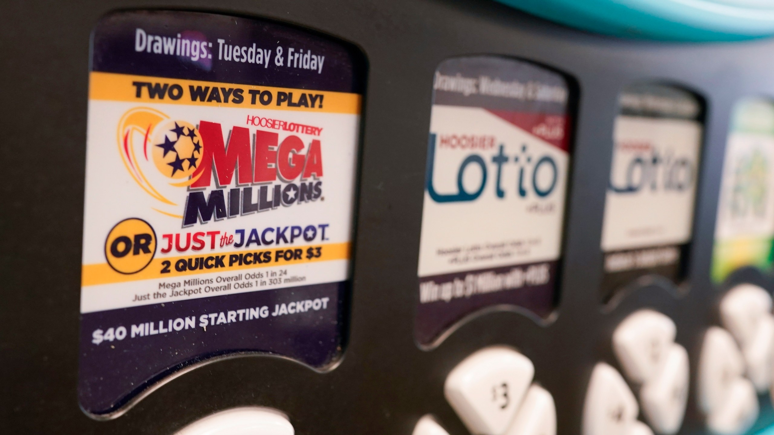 FILE - A Mega Millions logo is displayed on a vending machine at the Hoosier Lottery booth at the Indiana State Fair, Thursday, Aug. 3, 2023, in Indianapolis. (AP Photo/Darron Cummings, File)