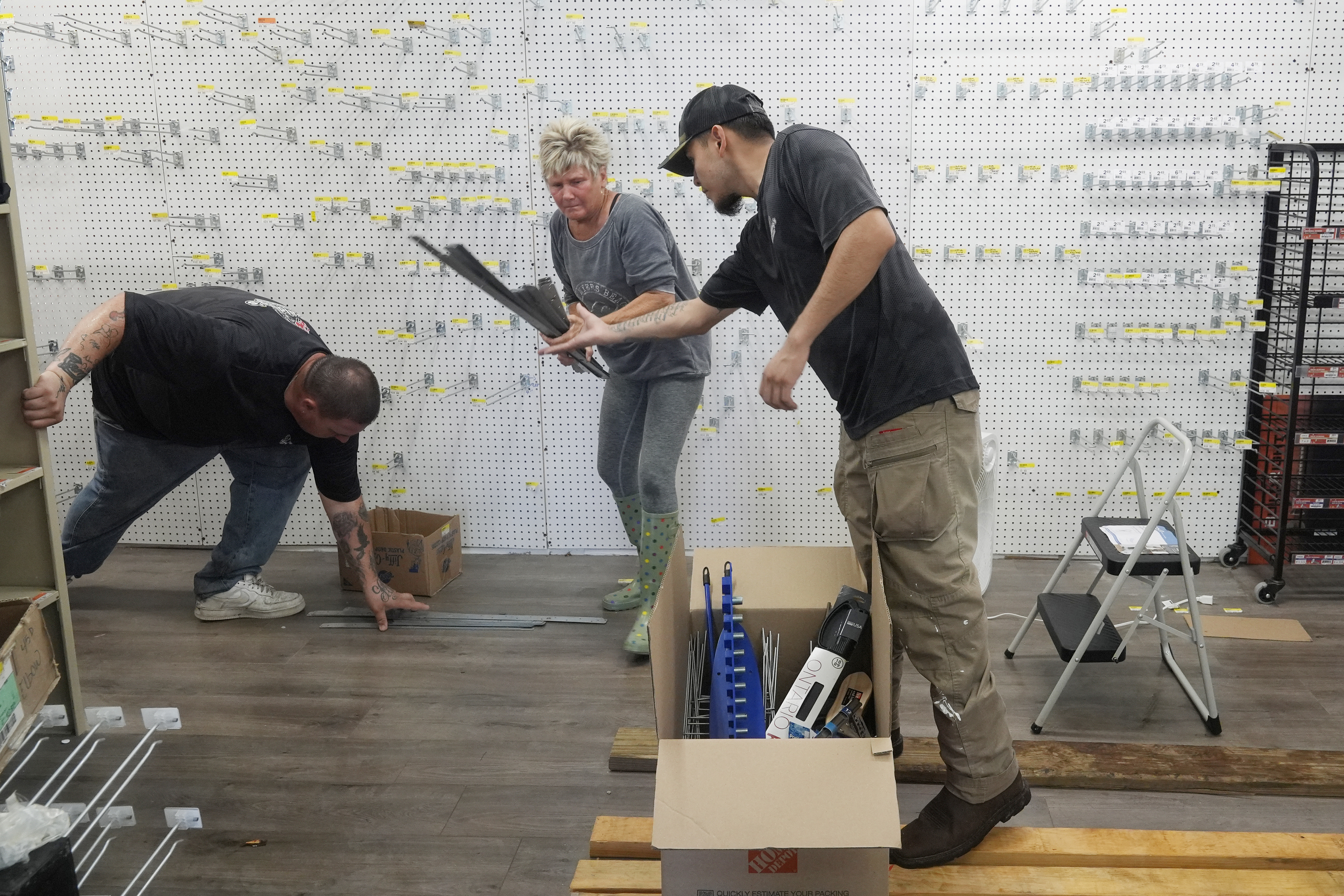 Employees at The Goodz hardware store, remove all the merchandise in advance of Hurricane Milton, Monday, Oct. 7, 2024, in Fort Myers Beach, Fla. (AP Photo/Marta Lavandier)