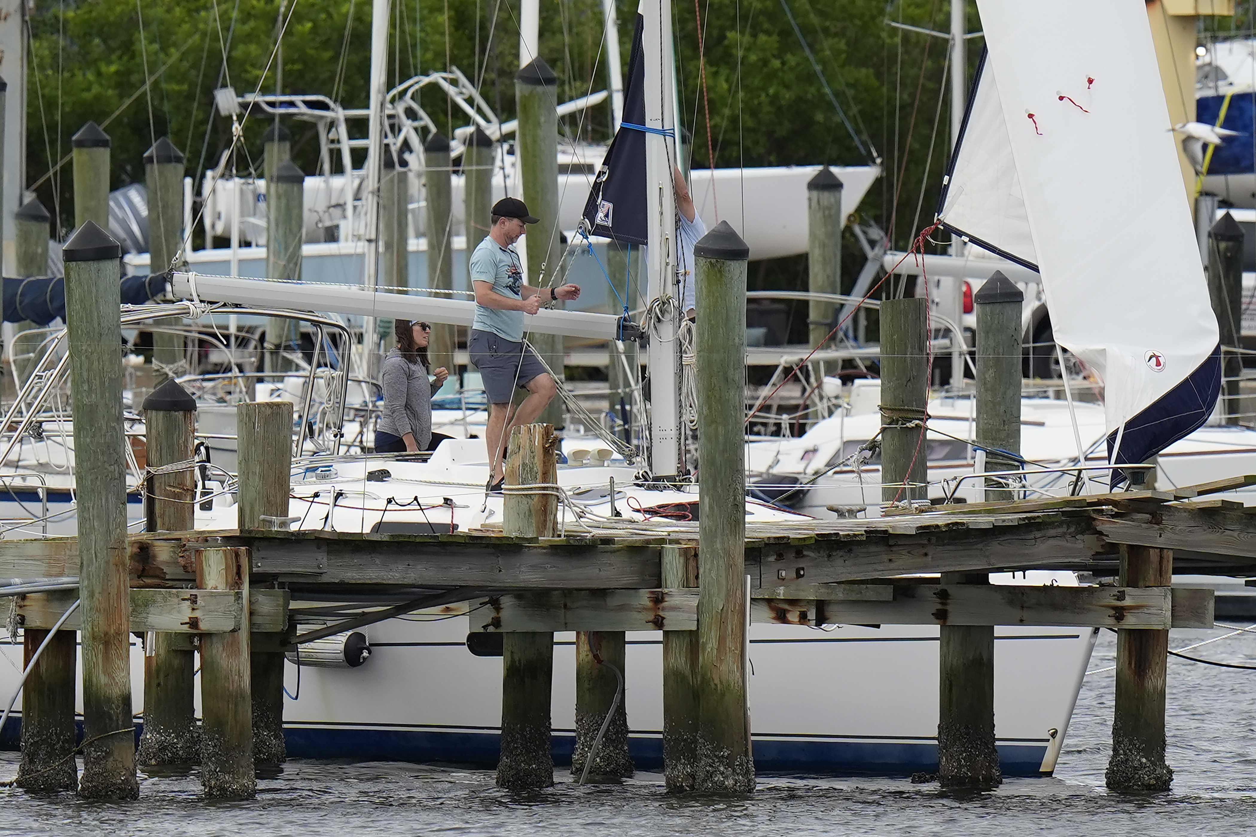 Owners try to secure their boat at the Davis Islands Yacht Clubs ahead a possible landfall by Hurricane Milton, Monday, Oct. 7, 2024, in Tampa, Fla. (AP Photo/Chris O'Meara)