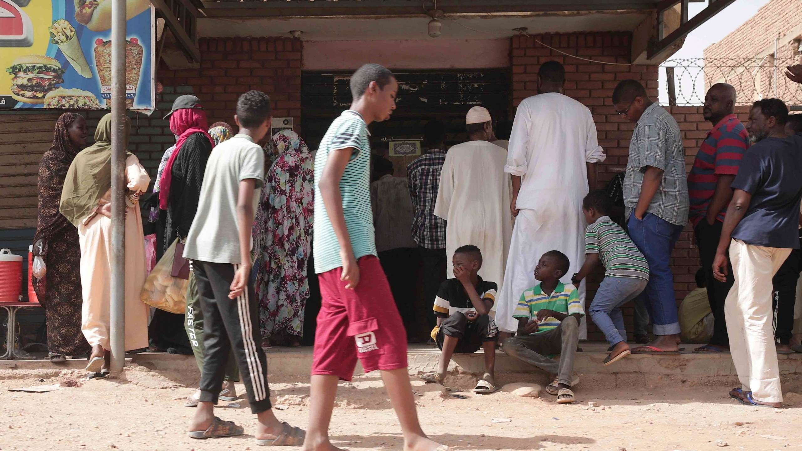 FILE -People line up in front of a bakery during a cease-fire in Khartoum, Sudan, May 27, 2023. (AP Photo/Marwan Ali, File)