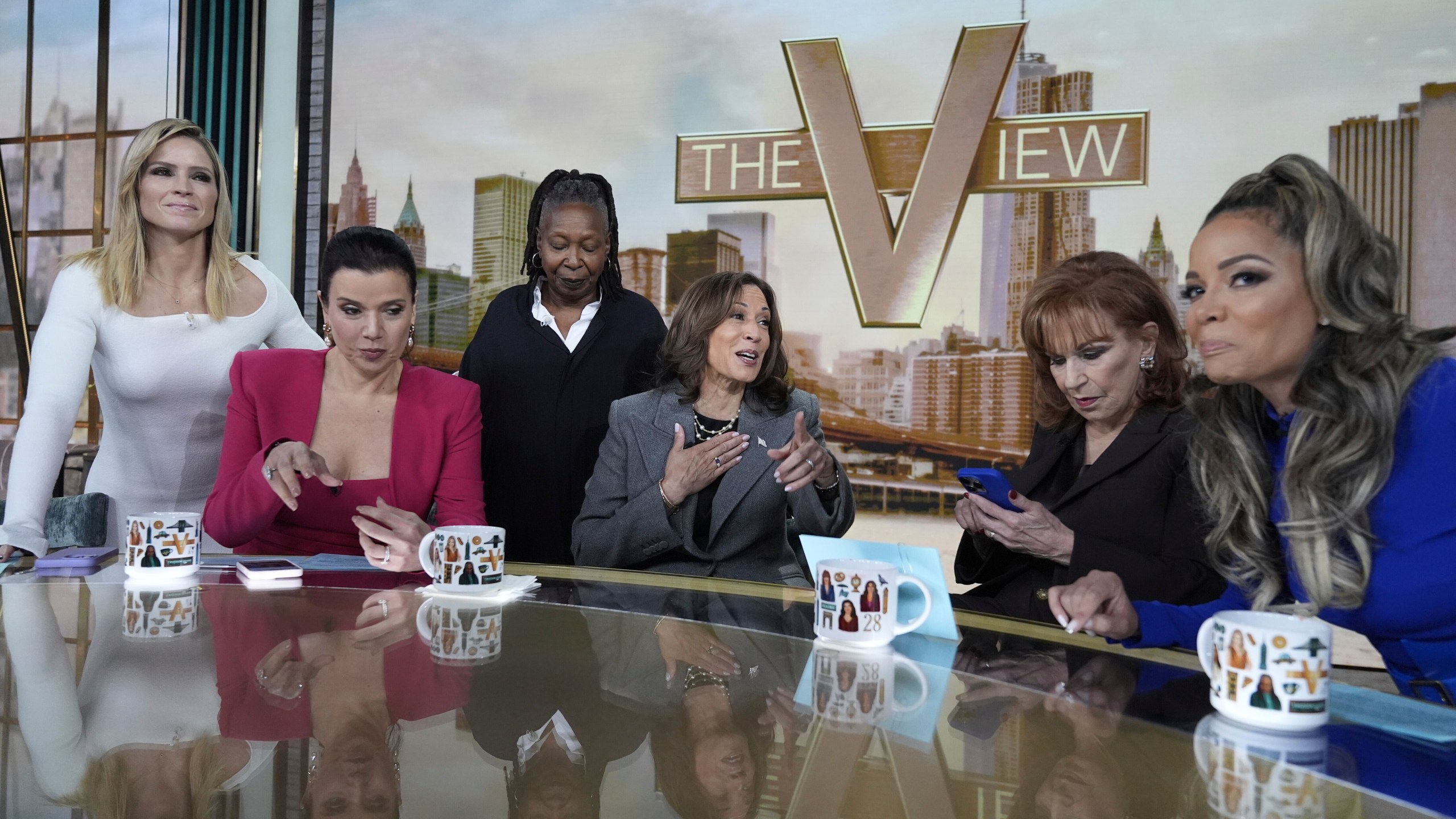 Democratic presidential nominee Vice President Kamala Harris chats with the hosts during a commercial break at The View, Tuesday, Oct. 8, 2024, in New York. From left are Sara Haines, Ana Navarro, Whoopi Goldberg, Harris, Joy Behar and Sunny Hostin. (AP Photo/Jacquelyn Martin)