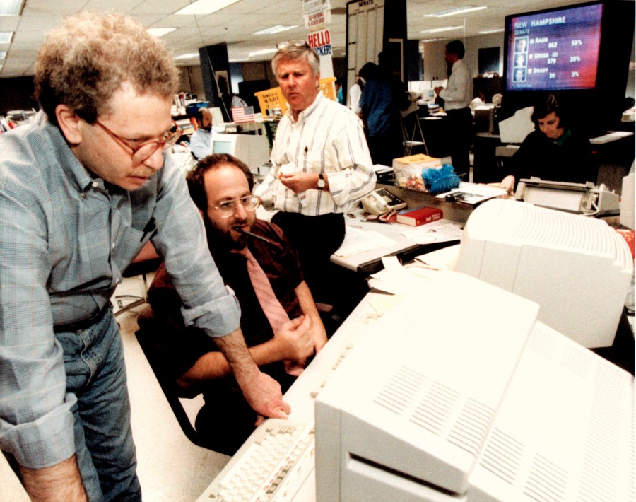 FILE - Associated Press journalists David Espo, bureau chief Jonathan Wolman and Walter Mears work on Election Day, November 1992, in Washington. (AP Photo, File)