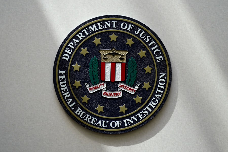 FILE - An FBI seal is seen on a wall on Aug. 10, 2022, in Omaha, Neb. Violent crime in the US dropped again in 2023, according to FBI statistics that show a continued trend downward after a coronavirus pandemic-era crime spike. The report released Monday shows overall violent crime ticked down an estimated 3% in 2023 from the year before, according to the FBI. (AP Photo/Charlie Neibergall, File)