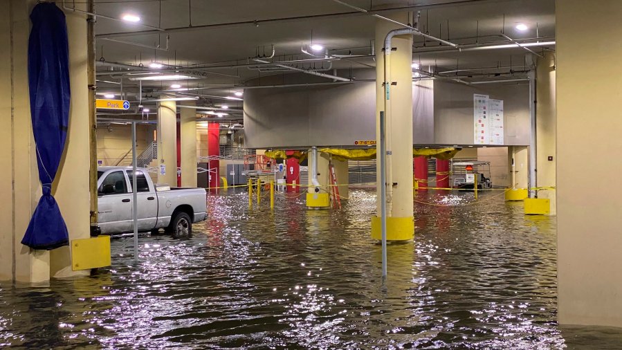 FILE - Flooding is seen at Tampa General Hospital as Tropical Storm Eta sends torrential downpours, storm surge flooding and wind across the Tampa Bay Area on Thursday, Nov. 12, 2020, in Tampa, Fla. (Luis Santana/Tampa Bay Times via AP)