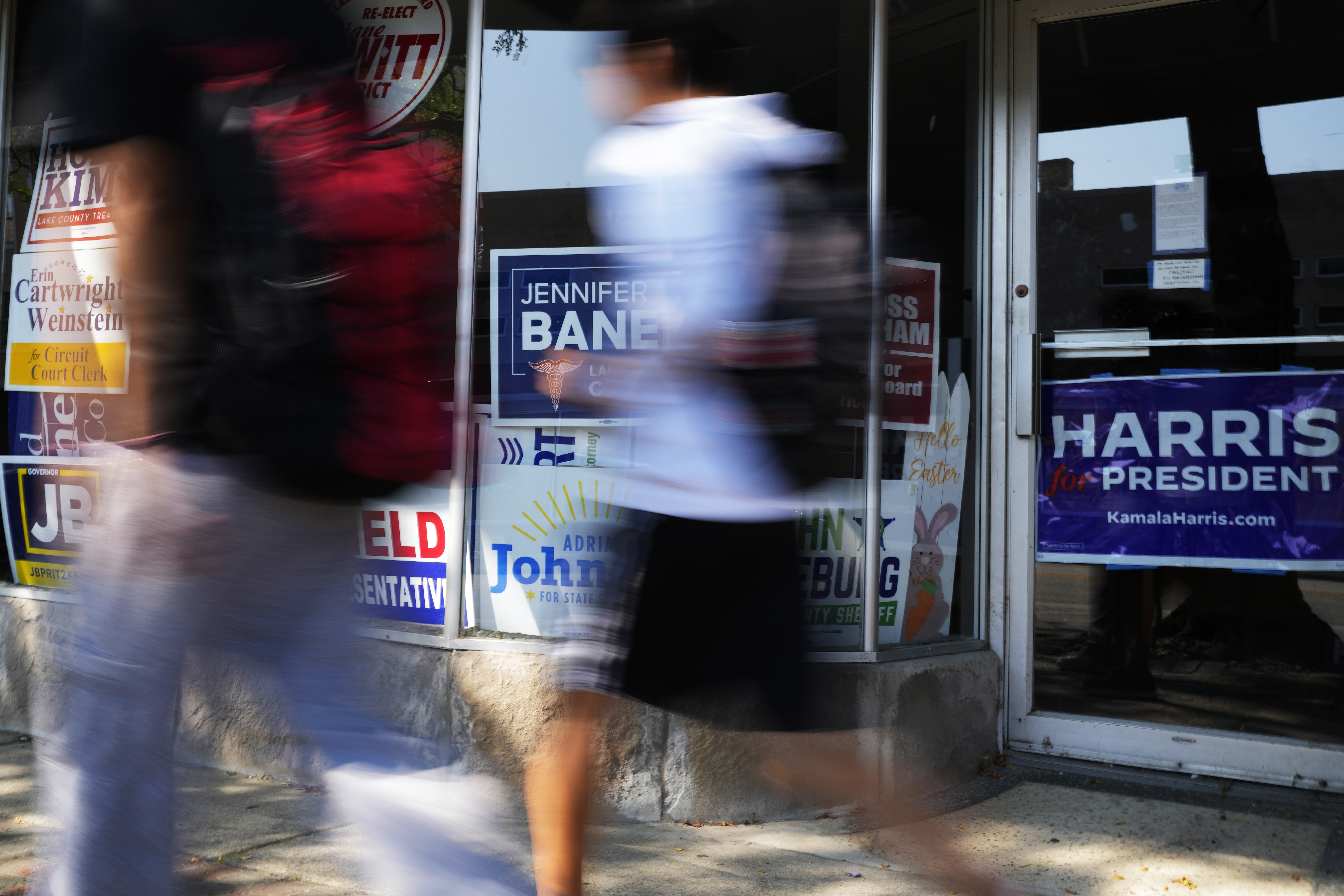 Pedestrians walk past the Waukegan Township Democrats office in Waukegan, Ill., Monday, Sept. 16, 2024. (AP Photo/Nam Y. Huh)