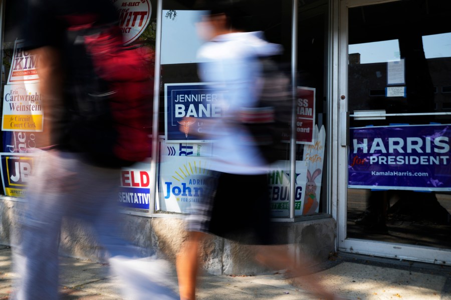 Pedestrians walk past the Waukegan Township Democrats office in Waukegan, Ill., Monday, Sept. 16, 2024. (AP Photo/Nam Y. Huh)