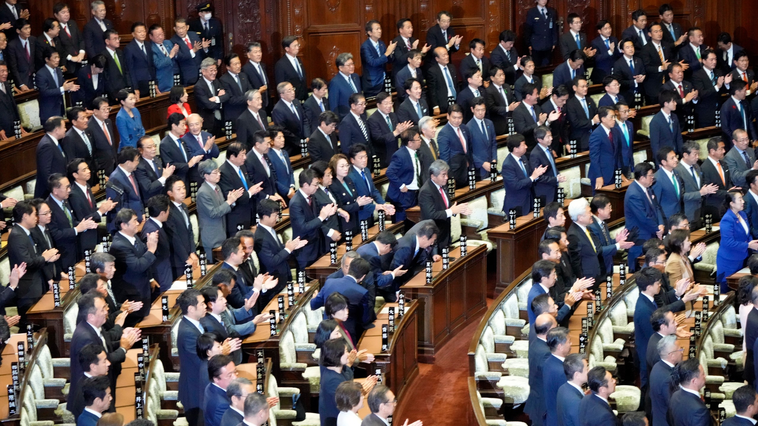 Lawmakers applaud after dissolving the lower house, the more powerful of the two parliamentary chambers, during an extraordinary Diet session at the lower house of parliament, Wednesday, Oct. 9, 2024, in Tokyo. (AP Photo/Hiro Komae)