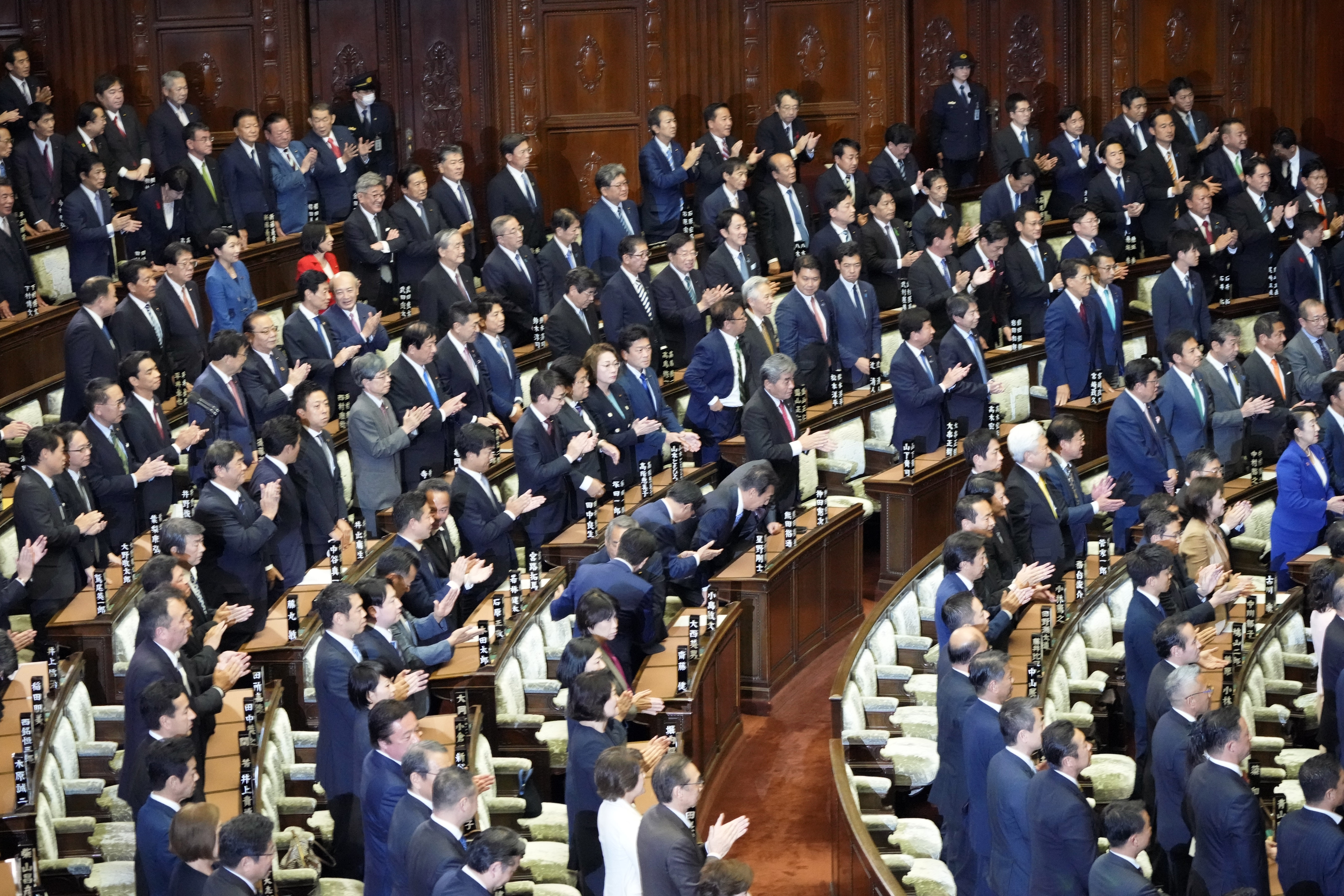 Lawmakers applaud after dissolving the lower house, the more powerful of the two parliamentary chambers, during an extraordinary Diet session at the lower house of parliament, Wednesday, Oct. 9, 2024, in Tokyo. (AP Photo/Hiro Komae)