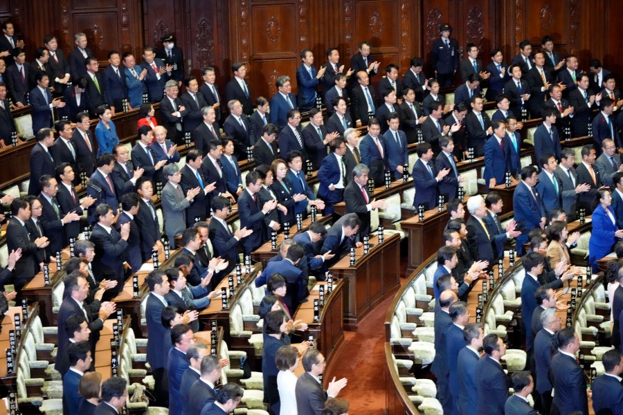 Lawmakers applaud after dissolving the lower house, the more powerful of the two parliamentary chambers, during an extraordinary Diet session at the lower house of parliament, Wednesday, Oct. 9, 2024, in Tokyo. (AP Photo/Hiro Komae)