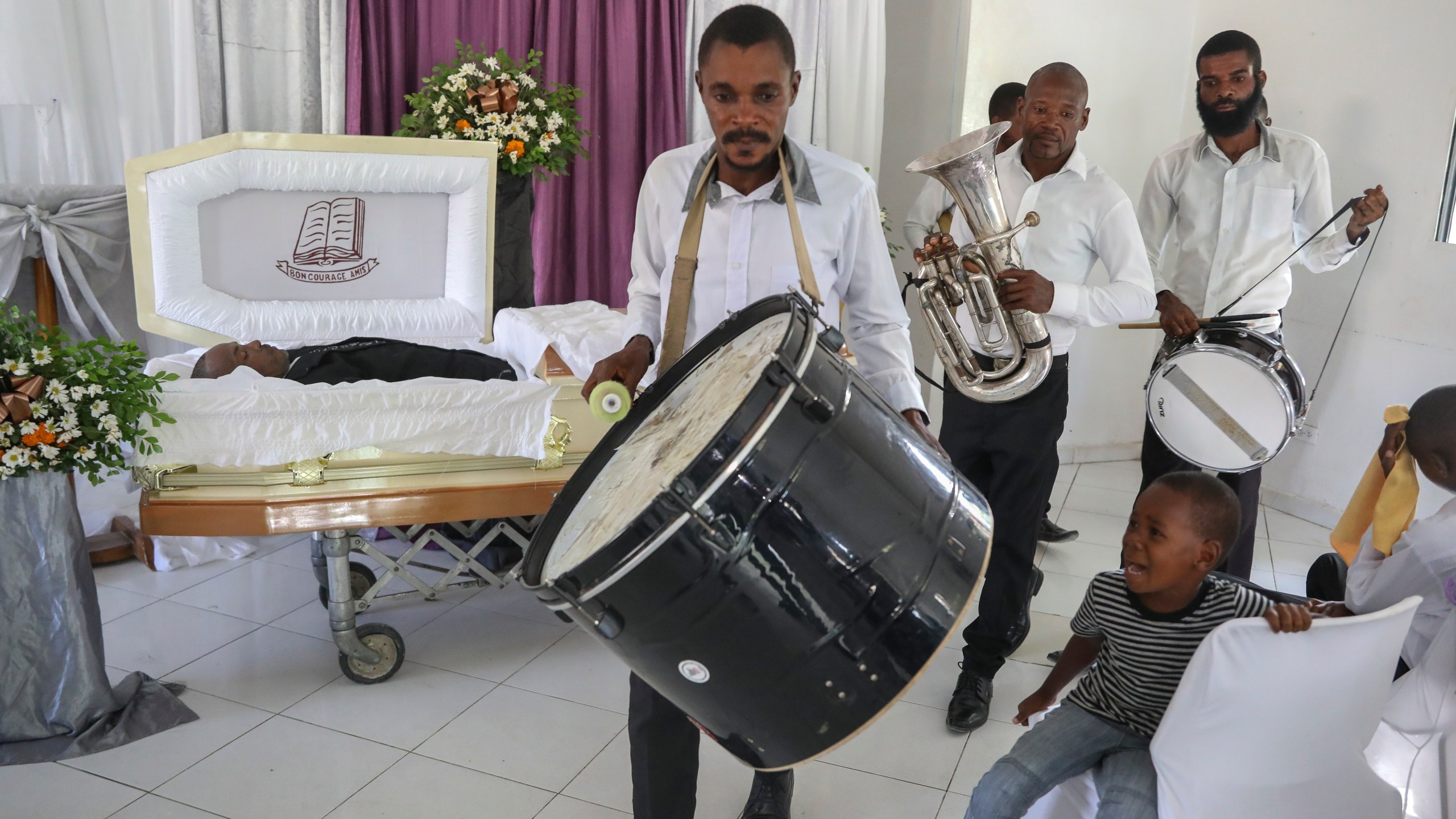 Musicians arrive at the funeral of Jean Louis Jeune Gracien, who was killed during an attack by armed gangs, in Pont-Sonde, Haiti, Tuesday, Oct. 8, 2024. (AP Photo/Odelyn Joseph)