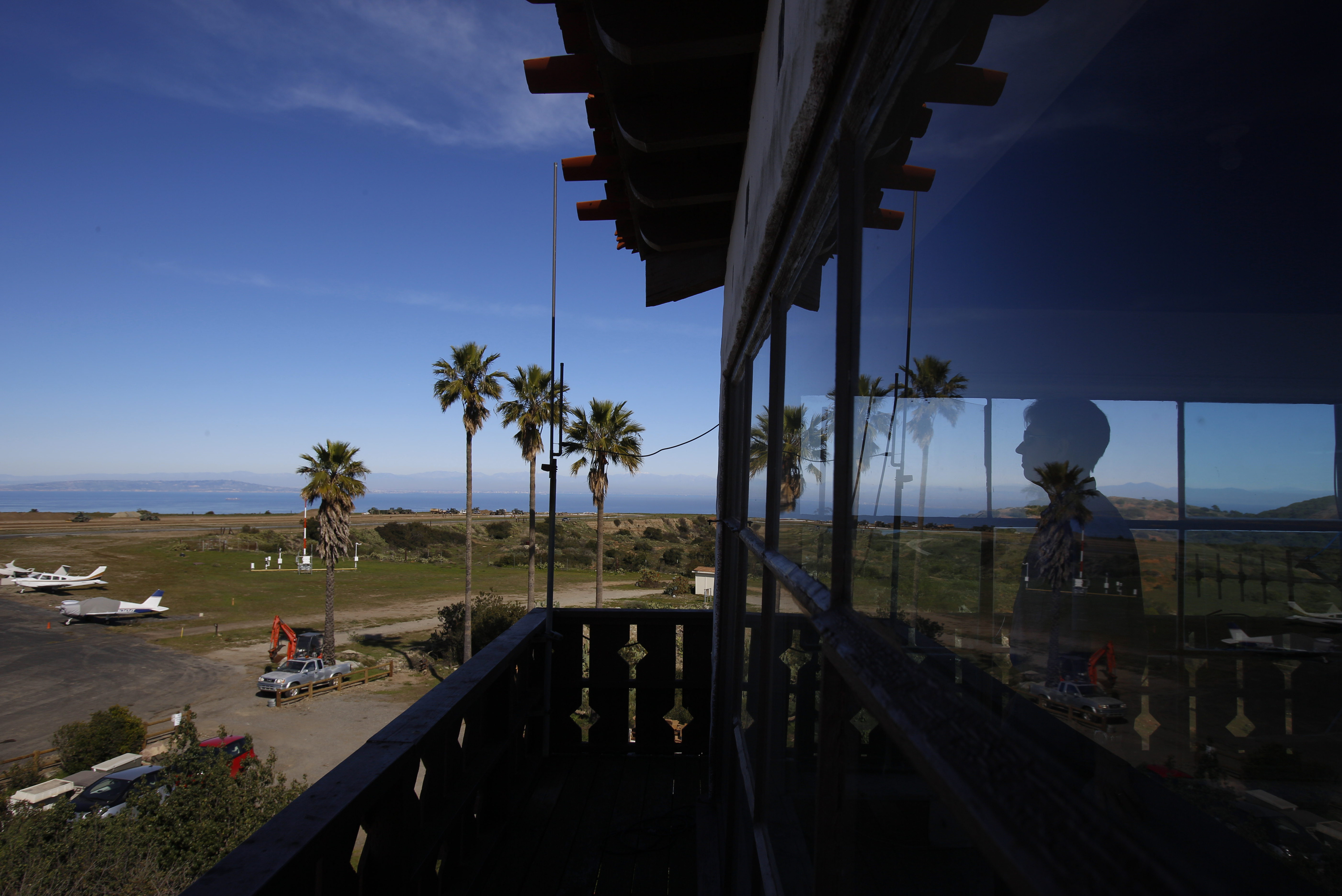 FILE - Catalina Island Conservancy Airport Manager Justin Bollum looks out of the airport tower as U.S. Marines and Navy Seabees rebuild the mountaintop runway on Santa Catalina Island, Calif., Friday, Jan. 25, 2019. (AP Photo/Damian Dovarganes, File)