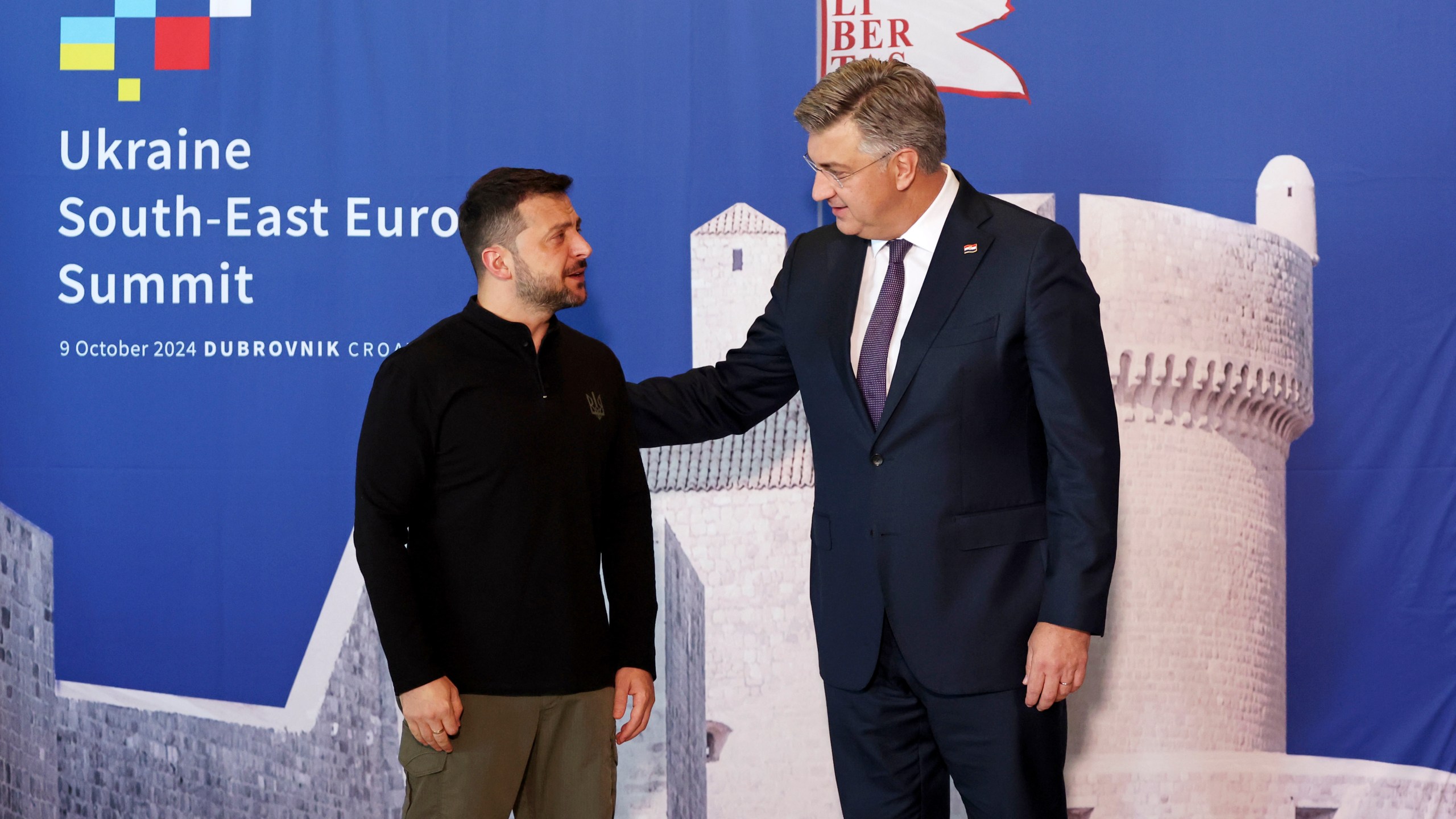 Ukrainian President Volodymyr Zelenskyy, left, is welcomed by Croatian Prime Minister Andrej Plenkovic at the Southeast Europe Croatia Ukraine summit in Dubrovnik, Croatia, Wednesday, Oct. 9, 2024. (Damir Sencar/Pool Photo via AP)