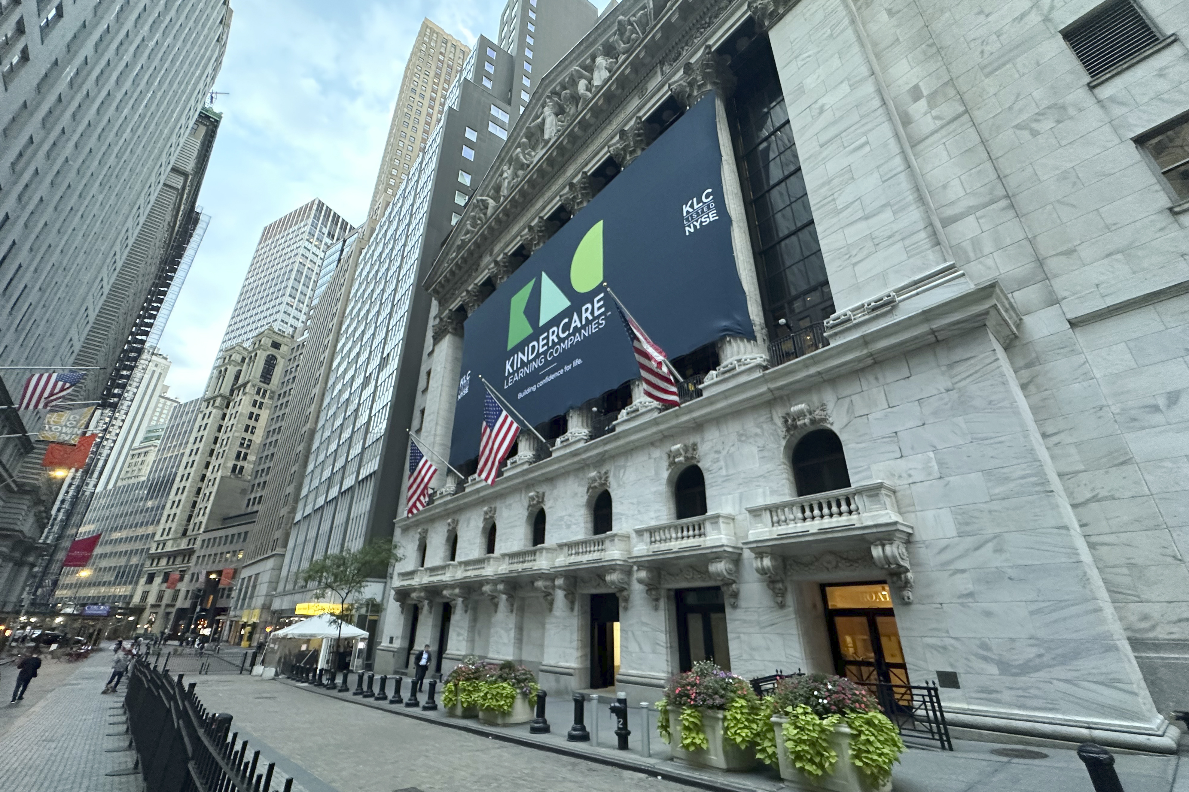 A banner for childhood learning company KinderCare hangs from the New York Stock Exchange ahead of the company's IPO on Wednesday, Oct. 9, 2024. (AP Photo/Peter Morgan, File)