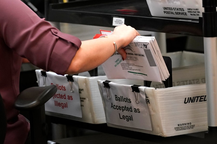 FILE - An election worker sorts vote-by-mail ballots at the Miami-Dade County Board of Elections, Monday, Oct. 26, 2020, in Doral, Fla. (AP Photo/Lynne Sladky, File)