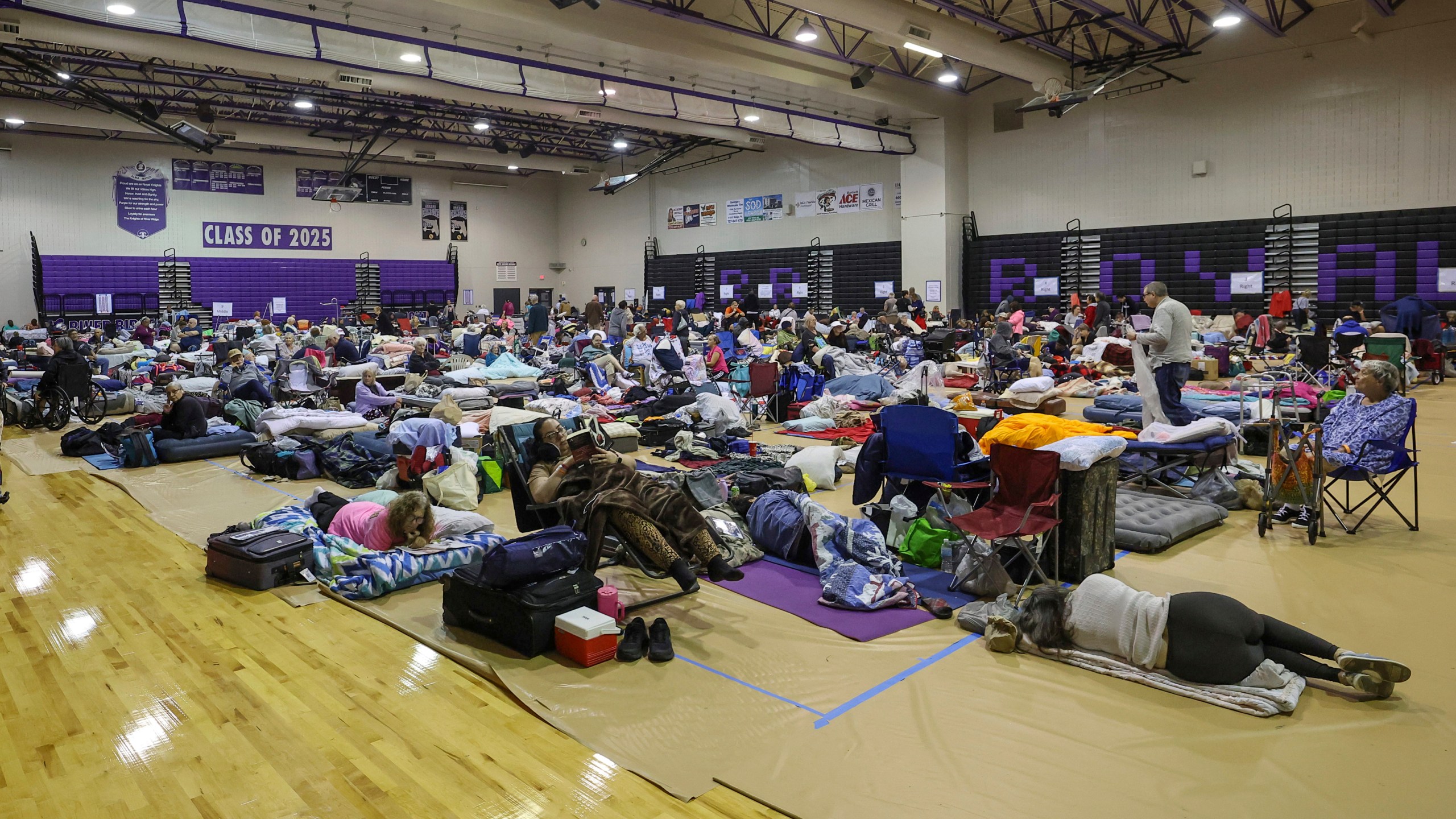 A view of some of the 700 evacuees in the gymnasium in shelter at River Ridge Middle/High School in preparation for Hurricane Milton on Wednesday, Oct. 9, 2024, in New Port Richey, Fla. (AP Photo/Mike Carlson)