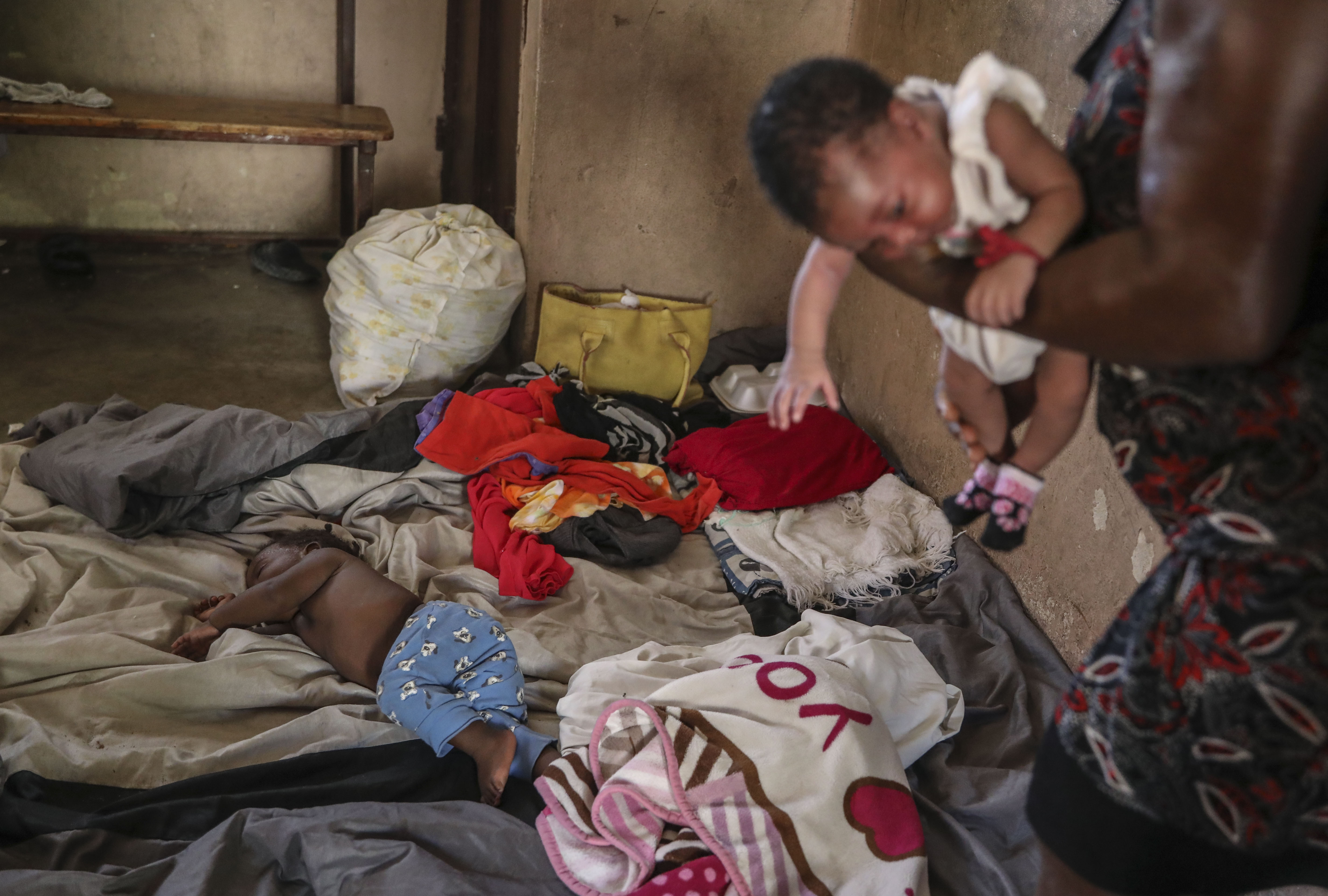 People displaced by armed gang attacks rest at the Antoinette Dessalines National School, a makeshift shelter, in Saint-Marc, Haiti, Sunday, Oct. 6, 2024. (AP Photo/Odelyn Joseph)