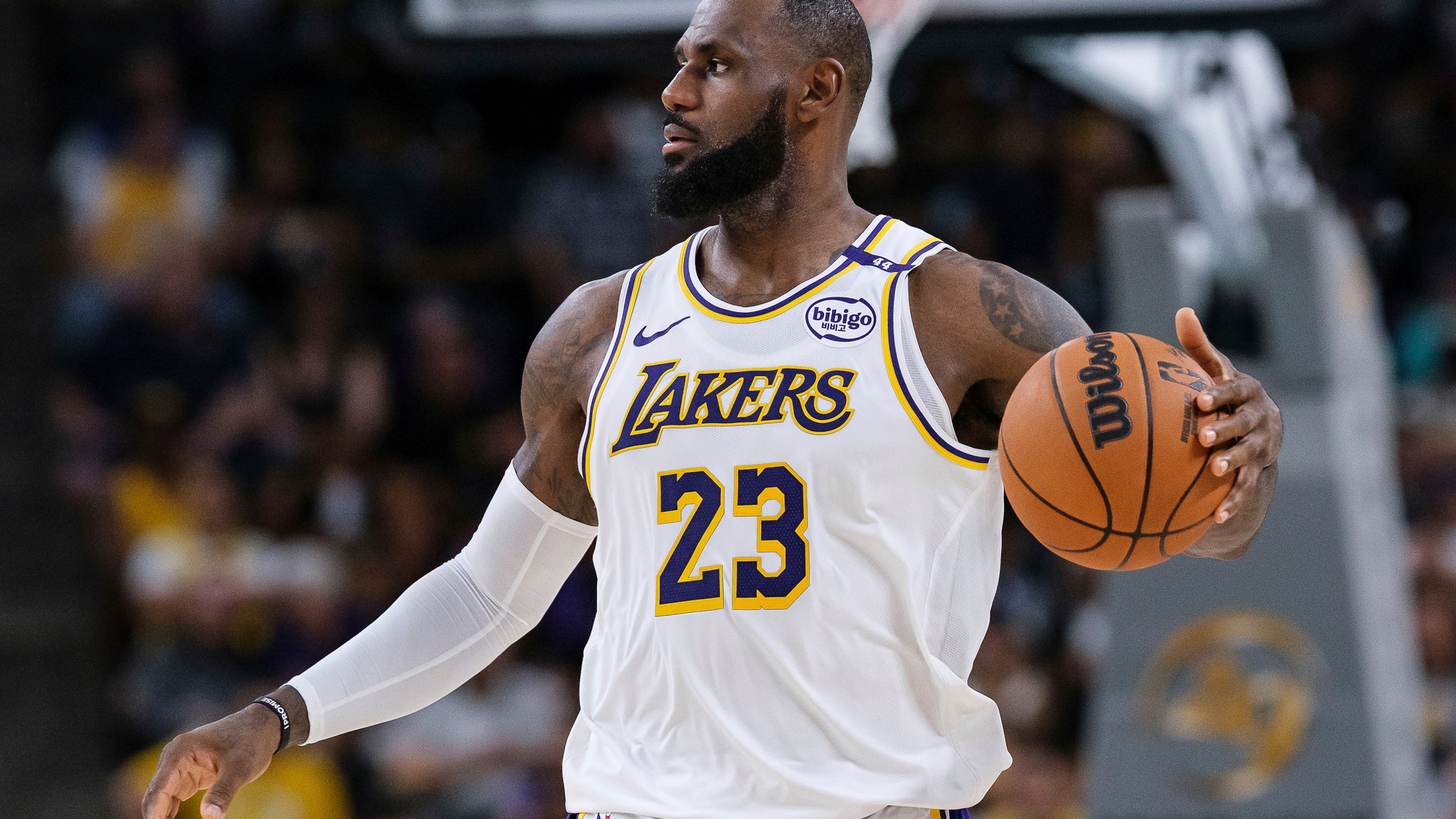 Los Angeles Lakers forward LeBron James (23) dribbles the ball during the first half of a preseason NBA basketball game against the Phoenix Suns, Sunday, Oct. 6, 2024, in Palm Desert, Calif. (AP Photo/William Liang)