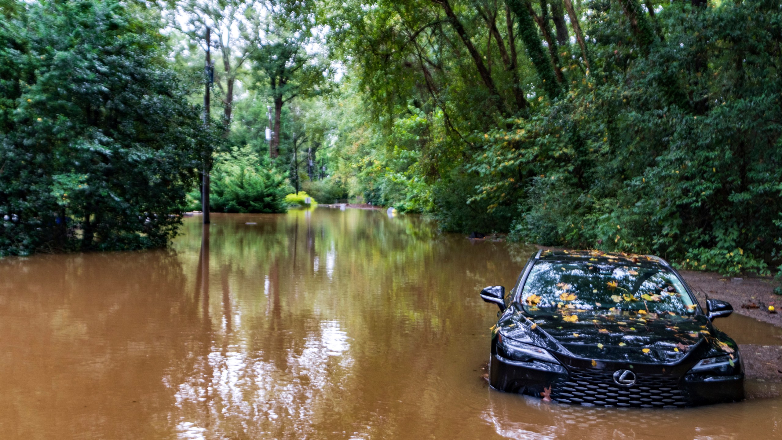 FILE - A partially submerged vehicle sits in floodwater from after Hurricane Helene passed the area, Sept 27, 2024, in Atlanta. (AP Photo/Jason Allen, File)