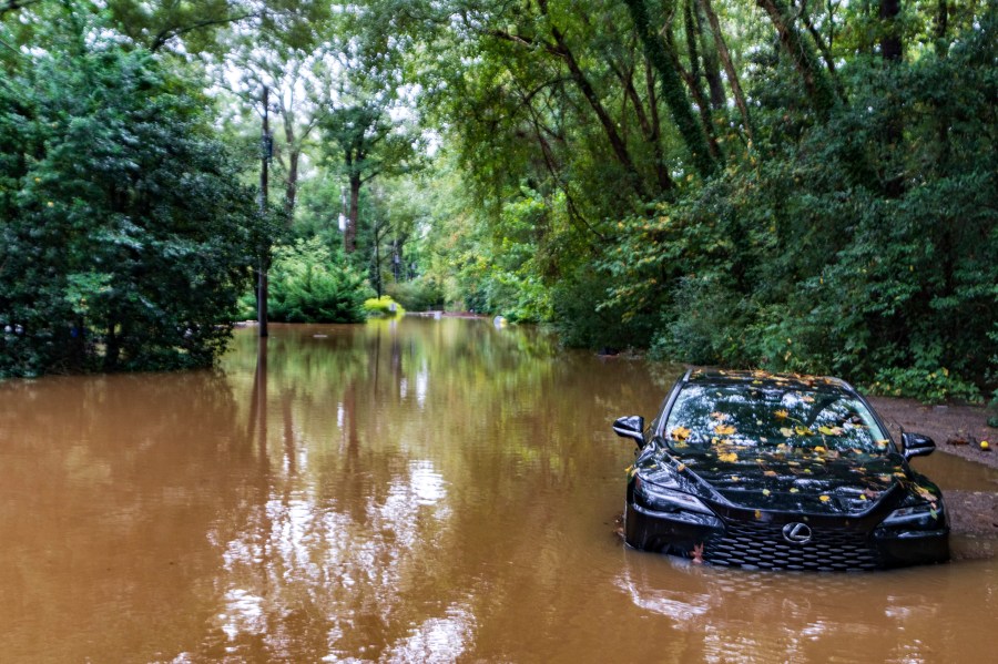 FILE - A partially submerged vehicle sits in floodwater from after Hurricane Helene passed the area, Sept 27, 2024, in Atlanta. (AP Photo/Jason Allen, File)