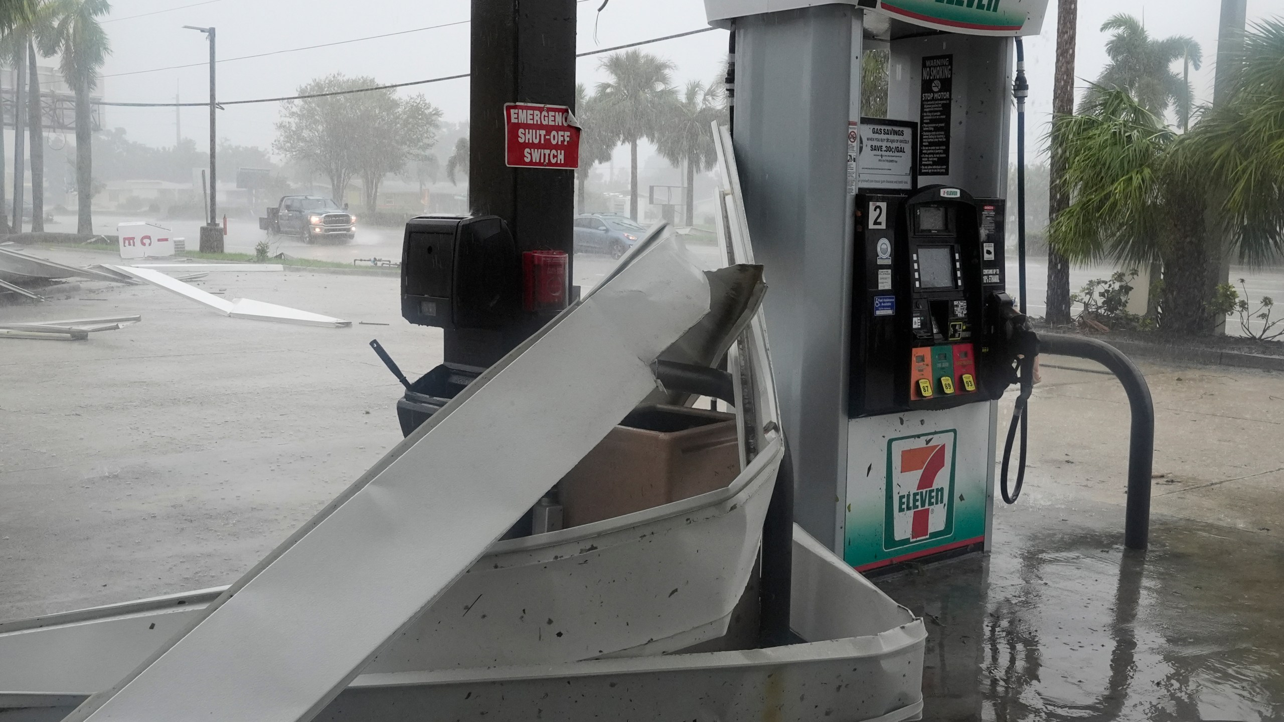 An apparent tornado caused by Hurricane Milton, tore the awning off a 7-Eleven convenient store, Wednesday, Oct. 9, 2024, in Cape Coral, Fla.(AP Photo/Marta Lavandier)